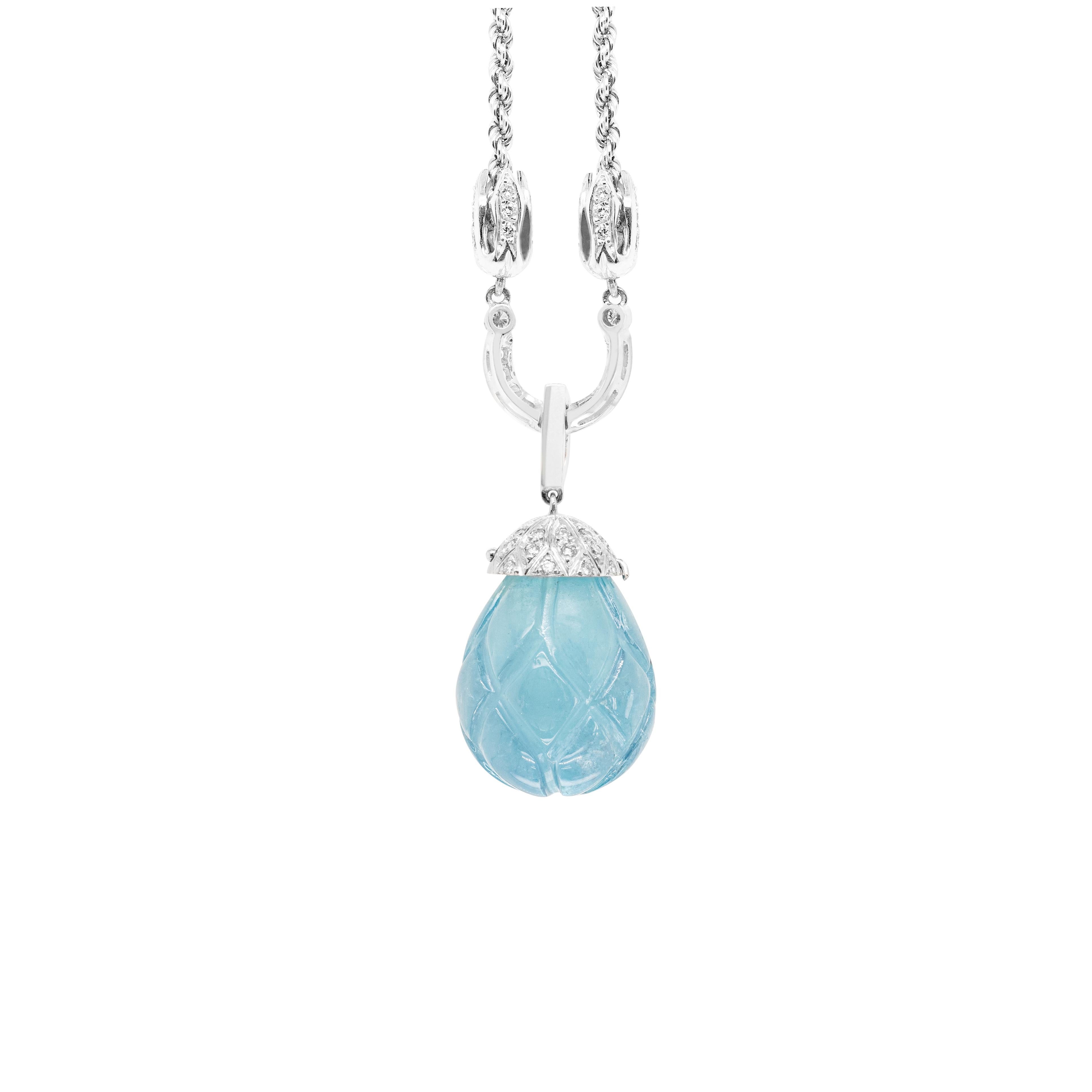 This gorgeous statement necklace features a carved cabochon aquamarine weighing approximately 30 carats held by a diamond set cup hanging from a channel set blue sapphire bale with an approximate weight of 0.12ct. The pendant drops from a horseshoe