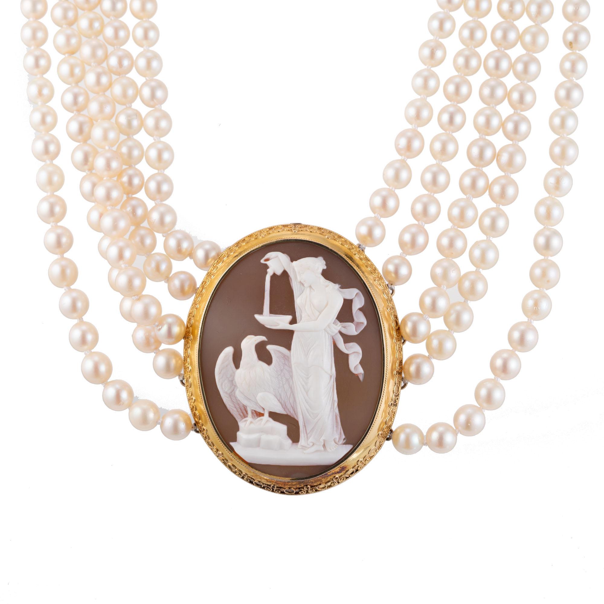 Vintage 1950's hand carved shell cameo and pearl necklace. The center is a hand carved Greek revival style old shell cameo circa 1900's, set in a 14k yellow gold bezel set frame with handmade embroidery. Attached are 5 strands of undyed, natural