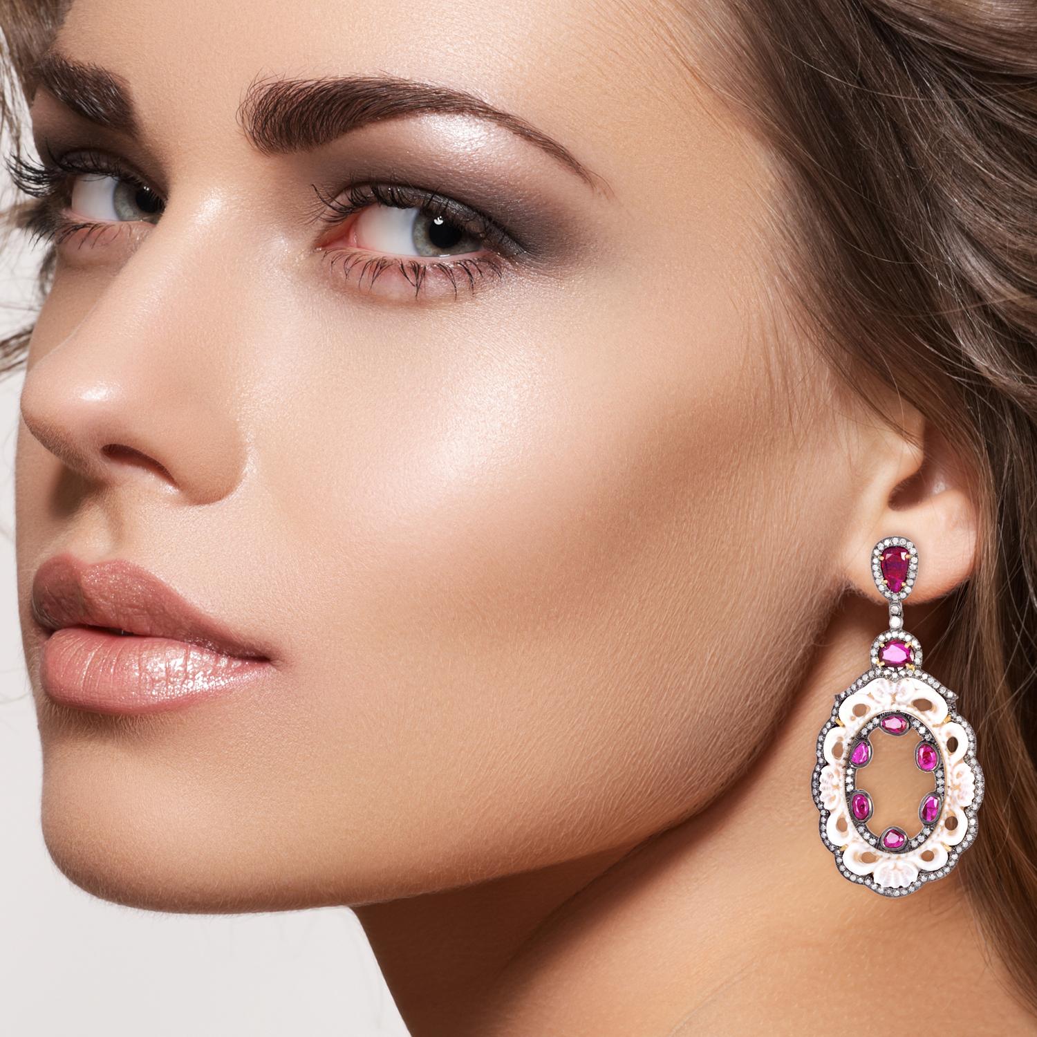 Cast in 18 karat gold. These beautiful earrings are set with 15.95 carats shell cameo, 6.03 carats ruby and 2.47 carats of sparkling diamonds. 

FOLLOW  MEGHNA JEWELS storefront to view the latest collection & exclusive pieces.  Meghna Jewels is