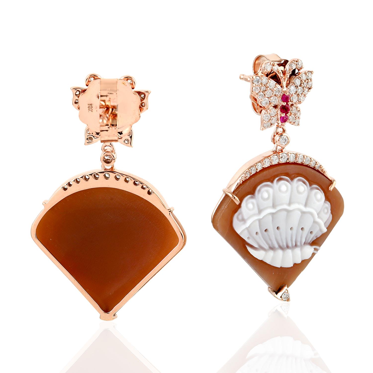 Cast in 18 karat gold. These beautiful cameo earrings are set with 18.25 carat carved cameo, .11 carats ruby and .63 carats of sparkling diamonds. 

FOLLOW  MEGHNA JEWELS storefront to view the latest collection & exclusive pieces.  Meghna Jewels is