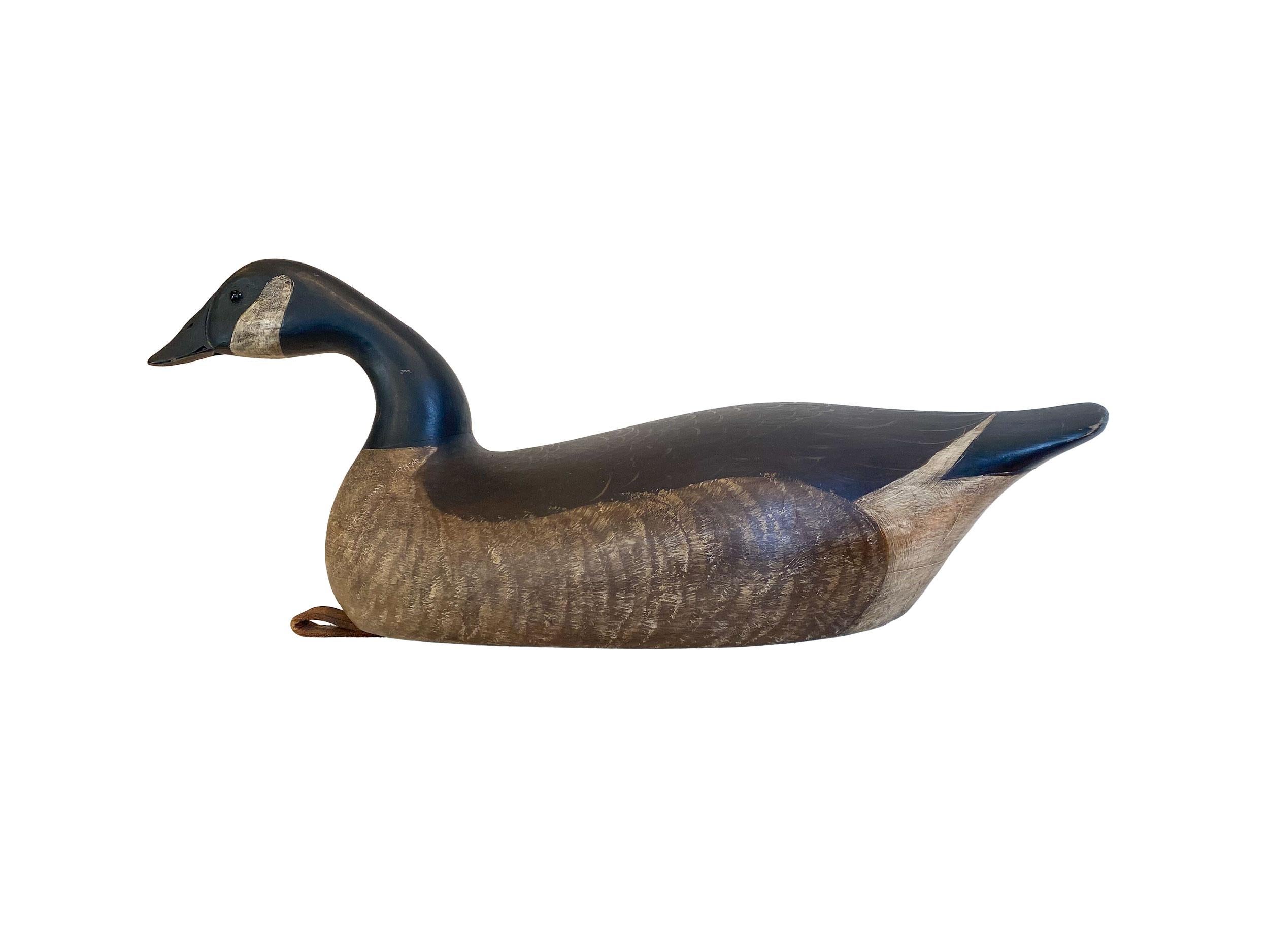 Canada swimming goose, hollow carved with glass eyes and lead plate
Signed/incised and titled on the bottom, 