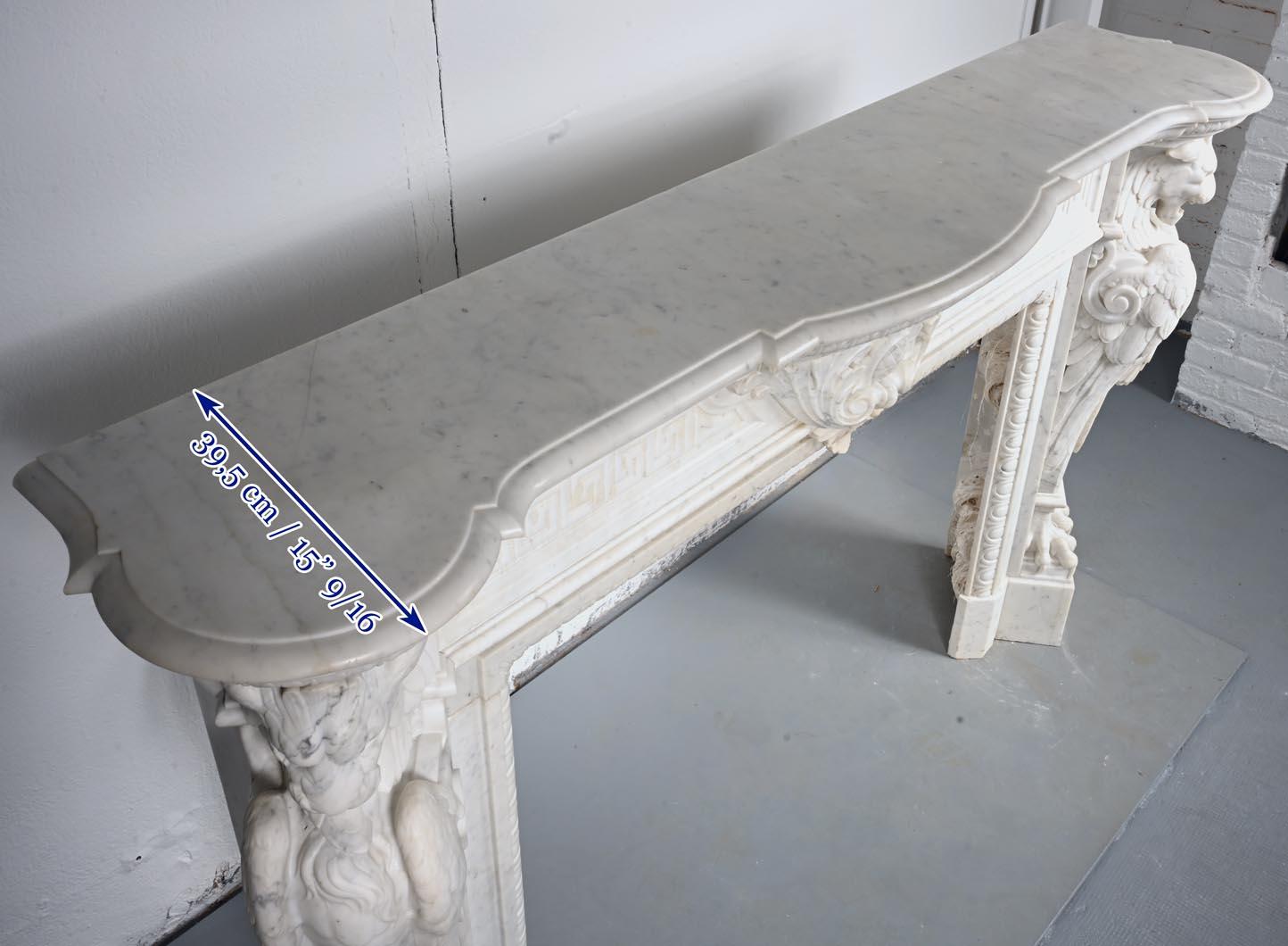 Carved Carrara marble mantel in the Napoleon III style with winged lions For Sale 6