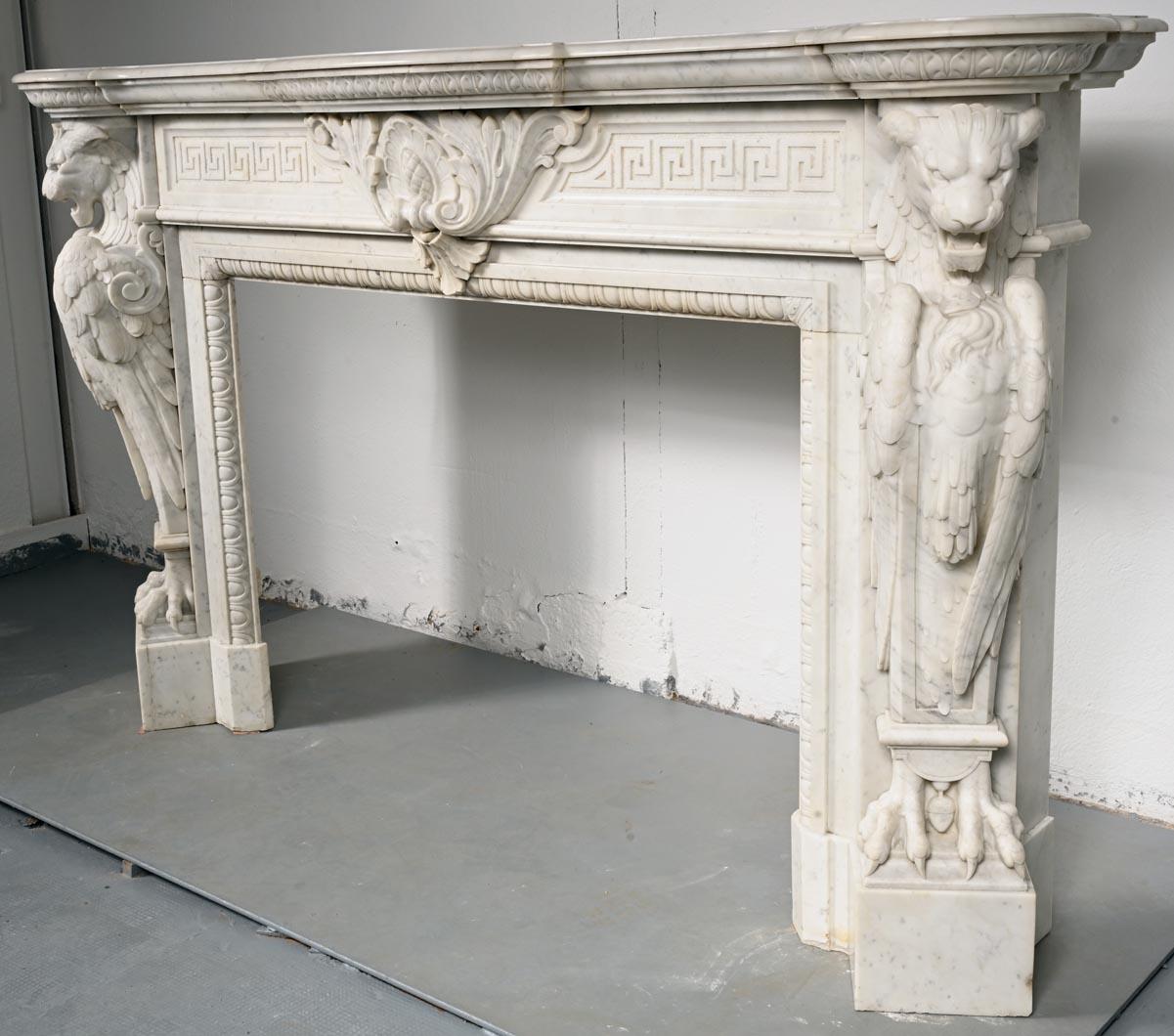 19th Century Carved Carrara marble mantel in the Napoleon III style with winged lions For Sale