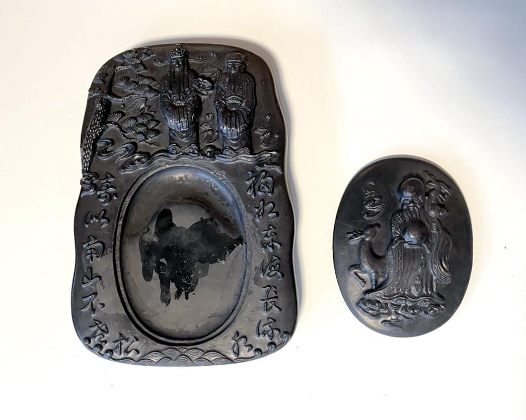 A black carved Chinese inkstone with an conforming oval cover circa early 20th century (late Qing to Republic period). The inkstone appears to be slate stone and was likely a She type (SheYan), one of the four famous inkstones in China that comes