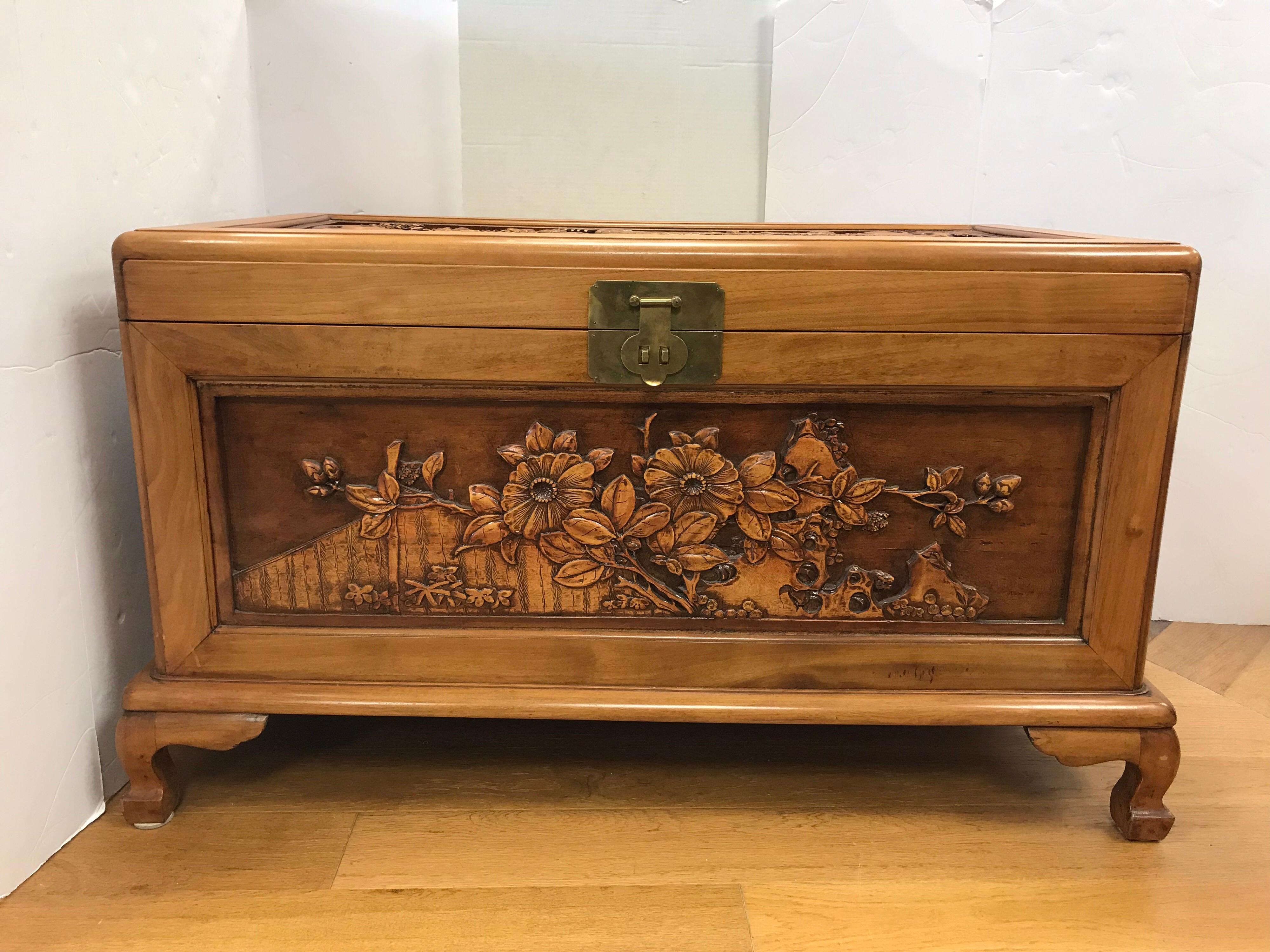 Chinese export trunk features stunning intricate carved scenery of birds and flowers. The different layers of carvings give it a three dimensional effect. Carvings are on front, back, sides and top. Brass closure opens to cedar interior. Use for