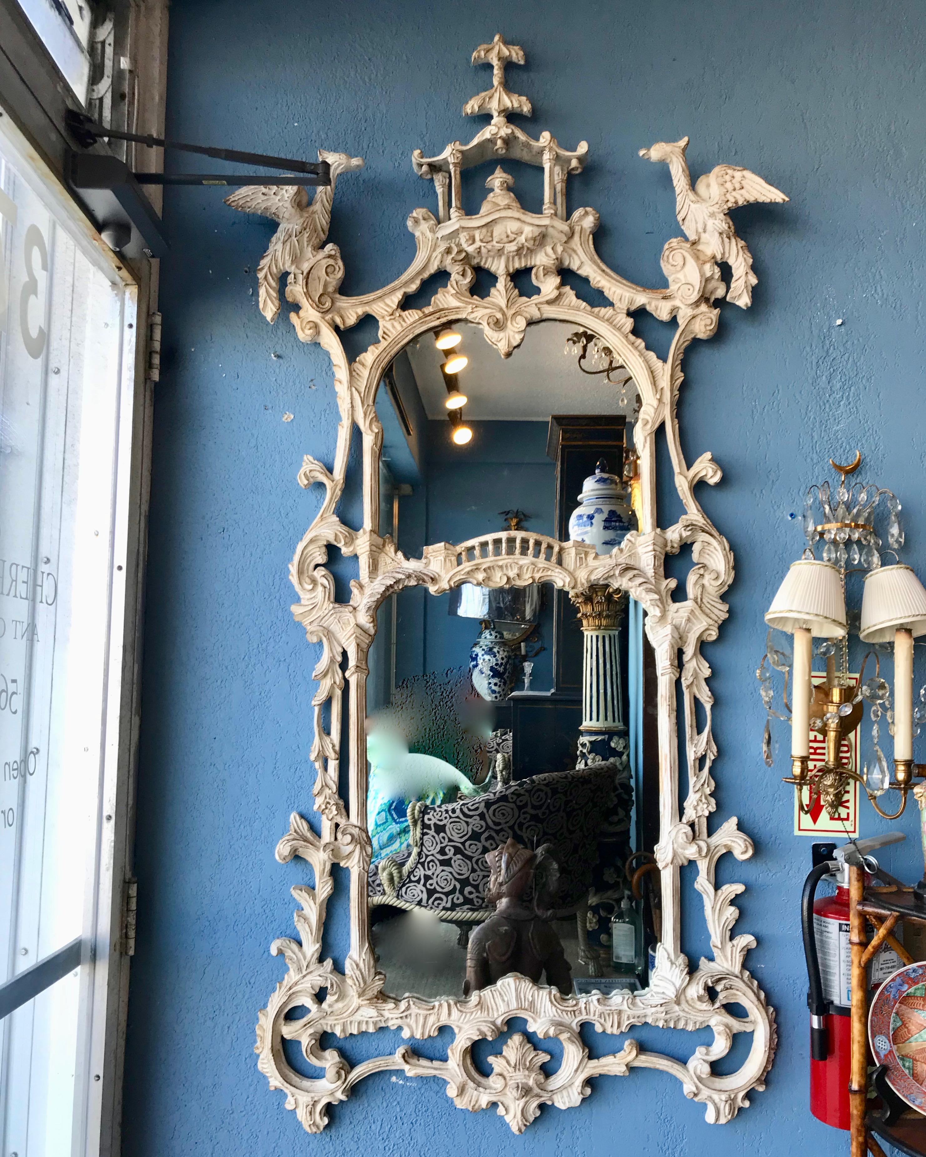 Appointed with a pagoda crown flanked  by Ho Ho birds and decorated 
with a white washed finish, the mirror is dramatic and imposing in scale.
Superior quality and workmanship.