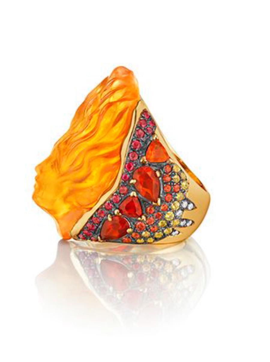 Specs: 
18k yellow gold ring with 72 carats of Carved Citrine, 5.25 carats Fire Opal, 2 carats Orange Sapphire, 2.70 carats Ruby, 1.95 carats Yellow Sapphire, and .52 carats Diamond. One-of-a-Kind, handmade, and spectacular award-winning couture