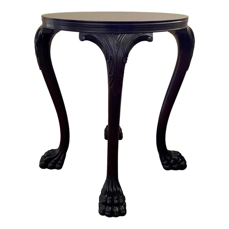 Round occasional claw foot cabriole leg side table by Thomas O'Brien for Hickory Chair Furniture. This beautifully carved end table features a dark walnut finish with bold scaled paw feet and traditional acanthus leaf details. Manufactures label to