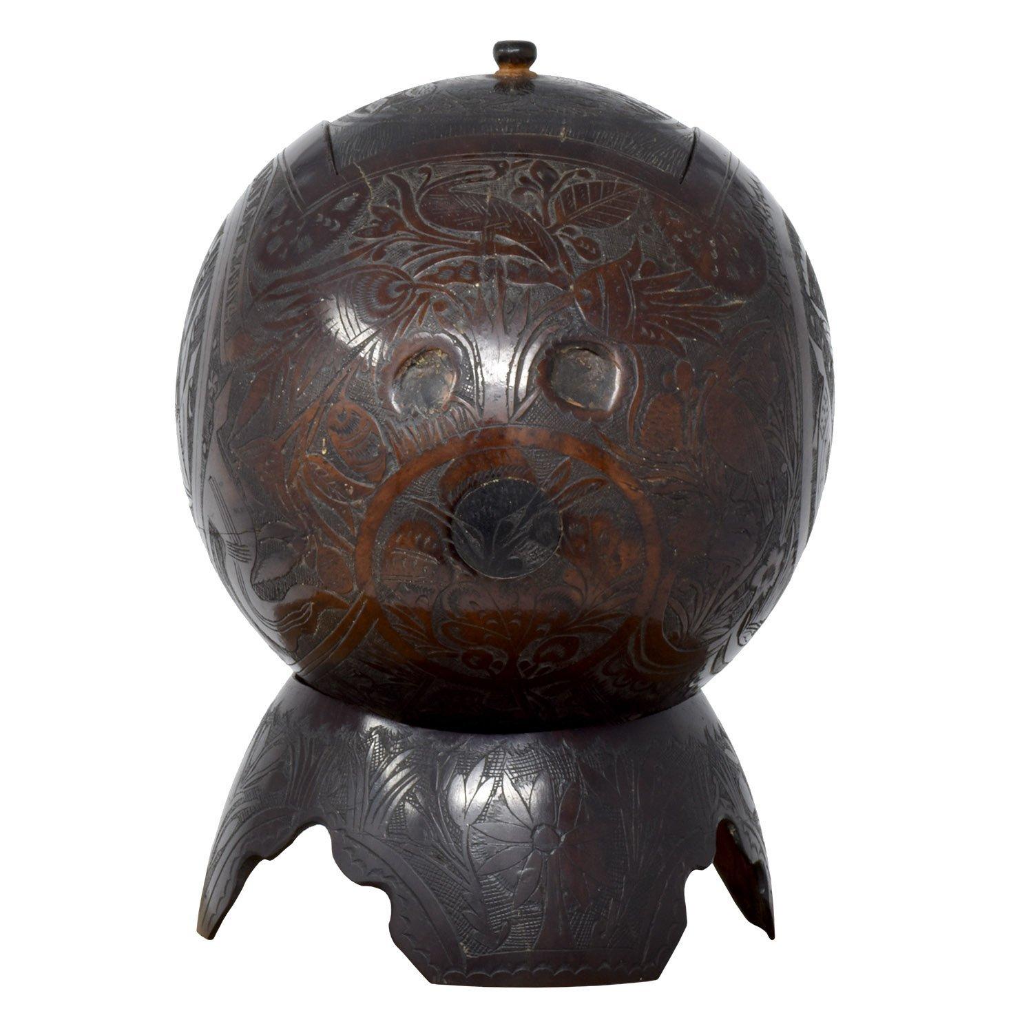 Carved coconut shell box
Nicaragua
1904
Carved coconut shells
6 x 6 x 4.5 in. / 15 x 11 x 11 cm

A finely and intricately carved box and stand. Engraved “Souvenir Te Nic. 1904”. In Mexico, incised coconut shells are often prison art. Minor