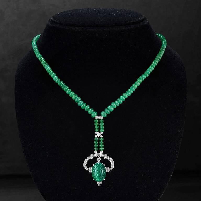 Carved Emerald 13.32 Carat from Colombia with All Beads Necklace weight 78.75 Carat, set on 18K White Gold Pendant with Brilliant Cut Diamond total 43 pieces 0.49 Carat.

The length of this Necklace is around 18 inches.