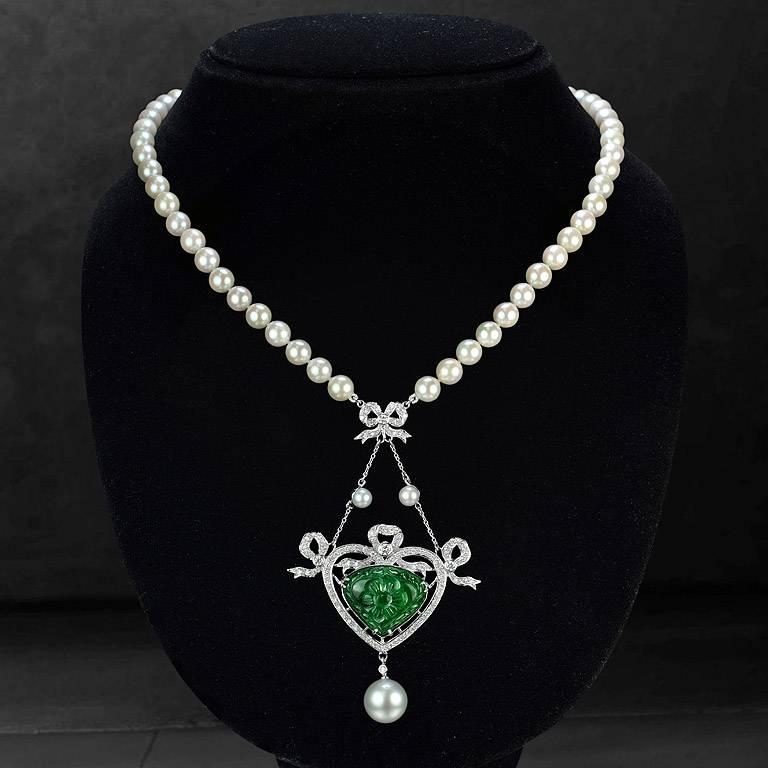 Carved Emerald Trillion Shape from Zambia 13.70 Carat set on 18K White Gold Pendant with Round Cut Diamond 88 pieces 1.11 Carat. Pearl 1 piece 10.60 Carat and 2 pieces 1.50 Carat on top of the Pendant. The pearl strand is Akoya Pearl from Japan