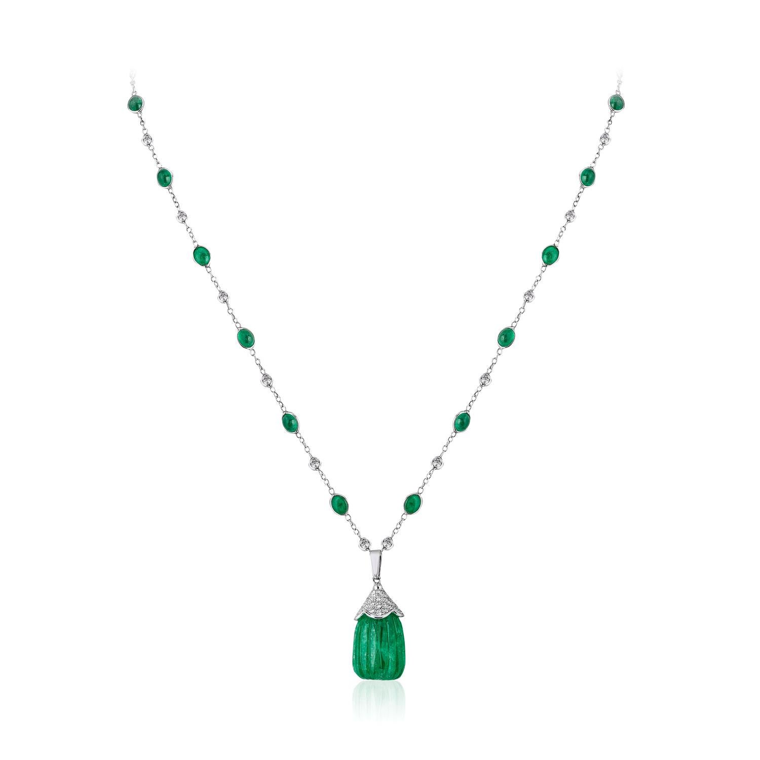 Carved Emerald Drop Pendant Emerald Cabochon and Diamond 18k Andreoli

This Andreoli pendant features a dazzling 42.95 carat carved Colombian emerald drop. The diamond by the yard contains 21.95 carat of oval emerald cabochons and the pendant is