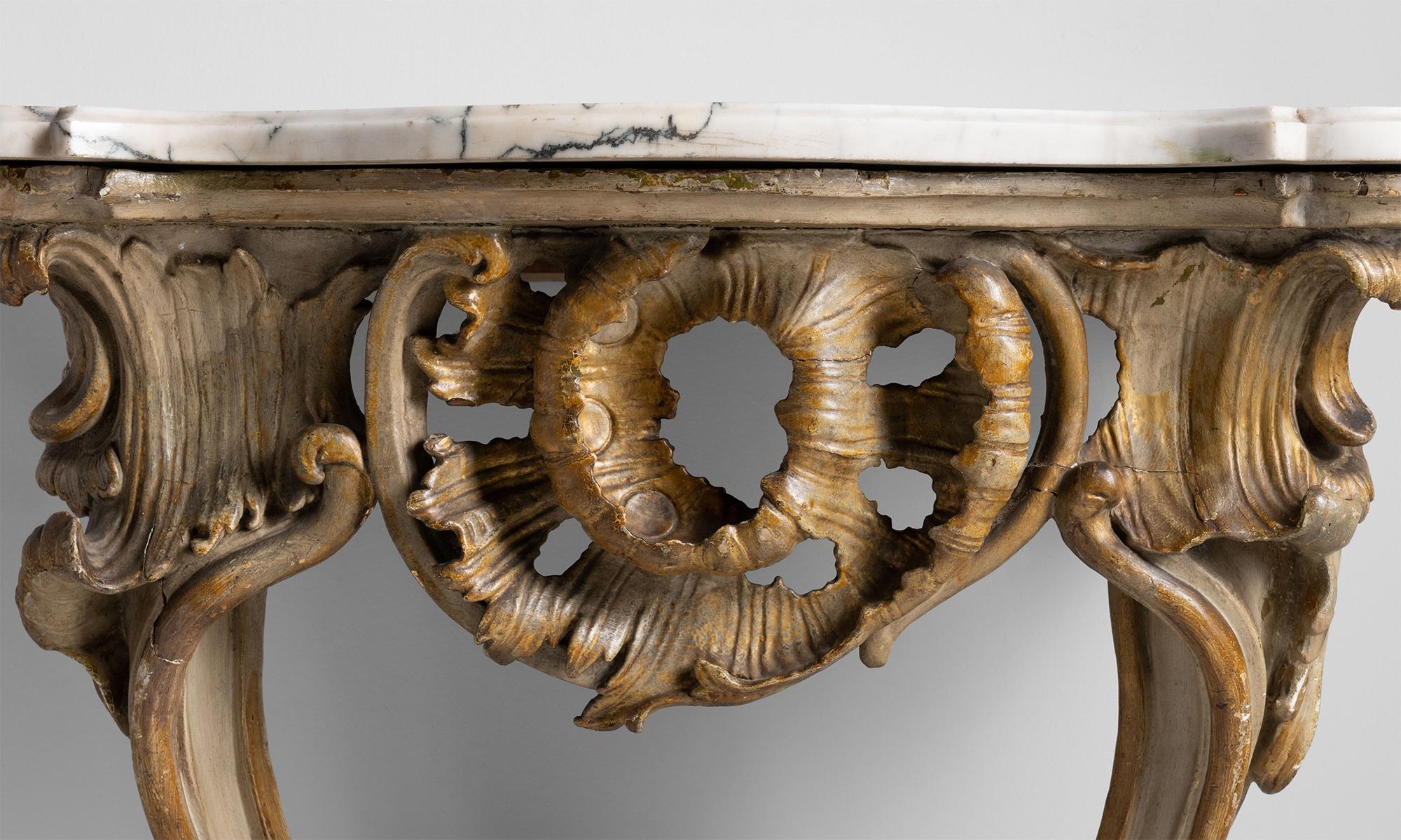 Carved console table with carrara marble top.

Italy Circa 1750.

Remnants of paint on the base with beautifully veined marble top.

Measures: 25.5