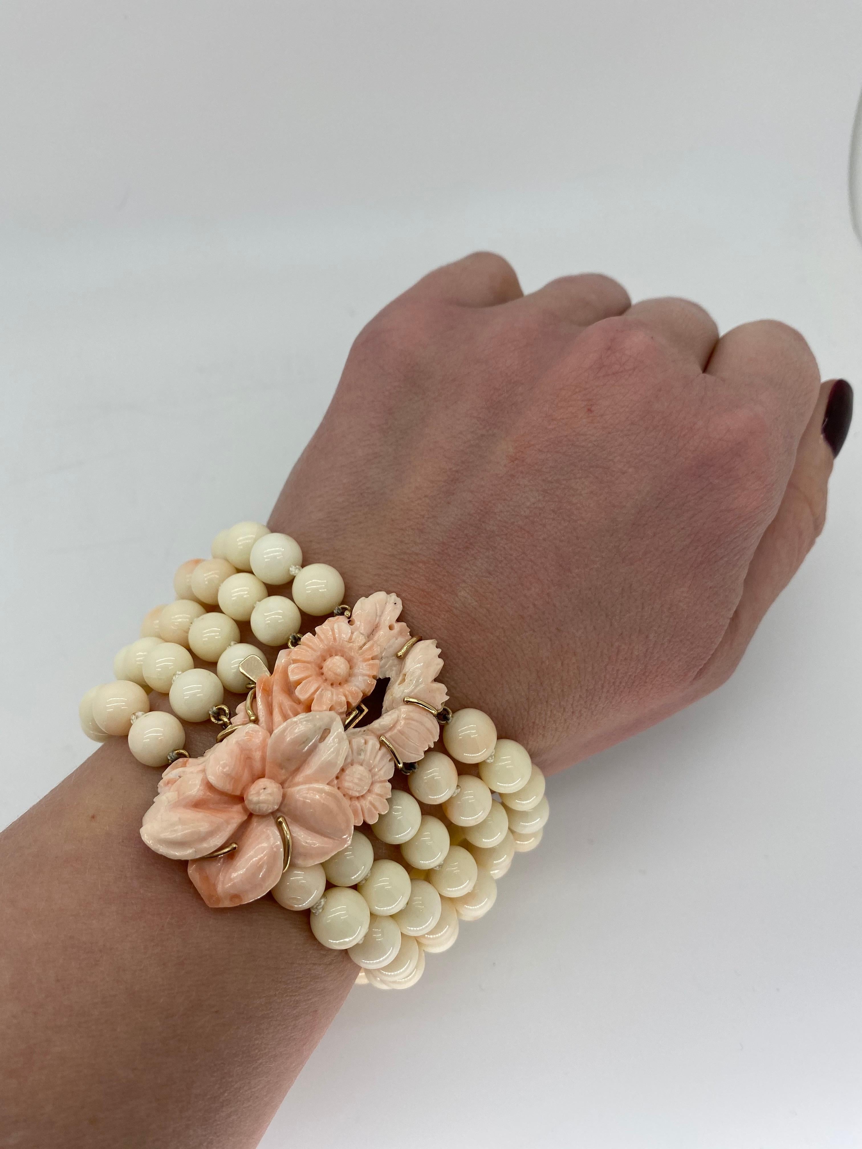 Unique hand crafted 5 strand carved coral bracelet made with 14k yellow gold. 

Gemstone: Coral
Gemstone Carat Weight: Coral Beads Approximately 8mm, Carved Coral Flowers Approximately 50x26mm
Metal: 14K Yellow Gold
Marked/Tested: Tested 14K