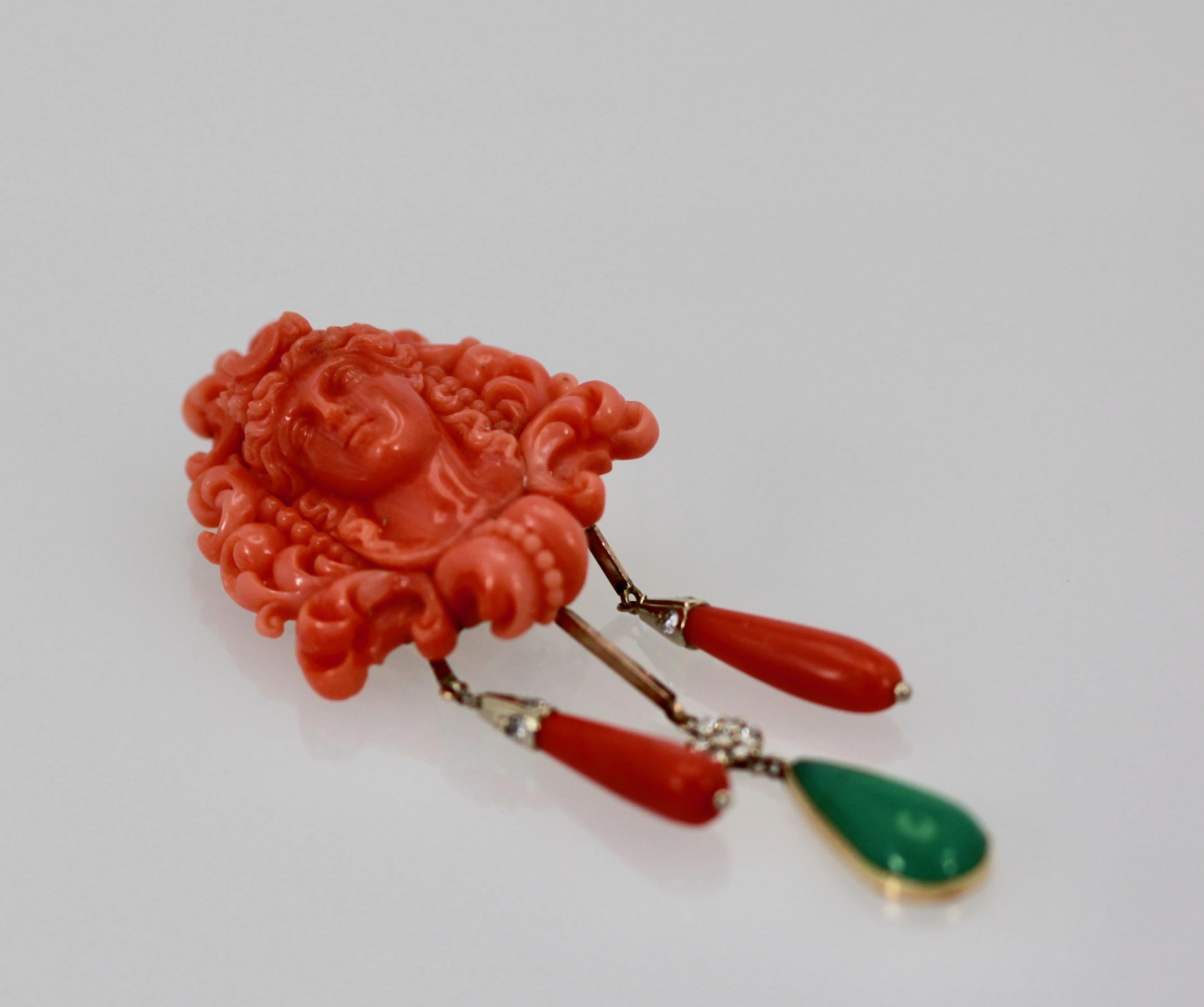 This lovely Cameo brooch is done in Mediterranean Coral with a lovely elaborate ladies face and headdress.  It is further decorated with two Coral drops and one Crystaphase drop. This piece is carved beautifully just look at her face and all the
