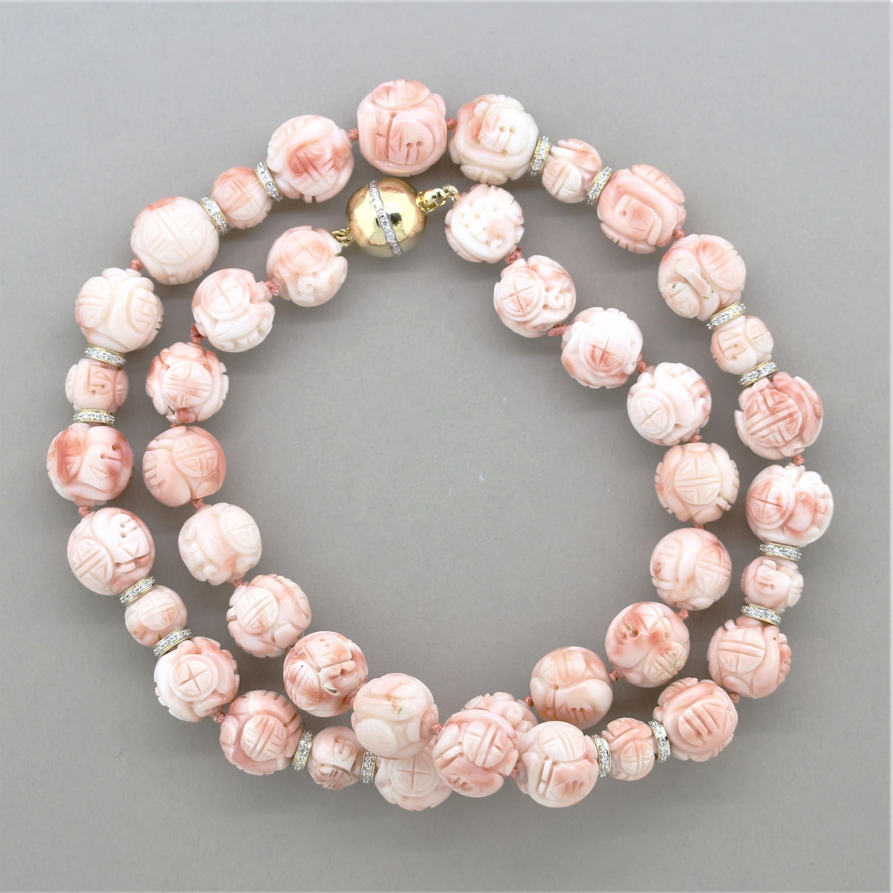 A unique vintage necklace featuring 43 pieces of natural carved coral beads with intricate designs. Accenting the coral is 1 carat of round brilliant-cut diamonds which are set in gold spacers between the coral beads in the front as well as set on