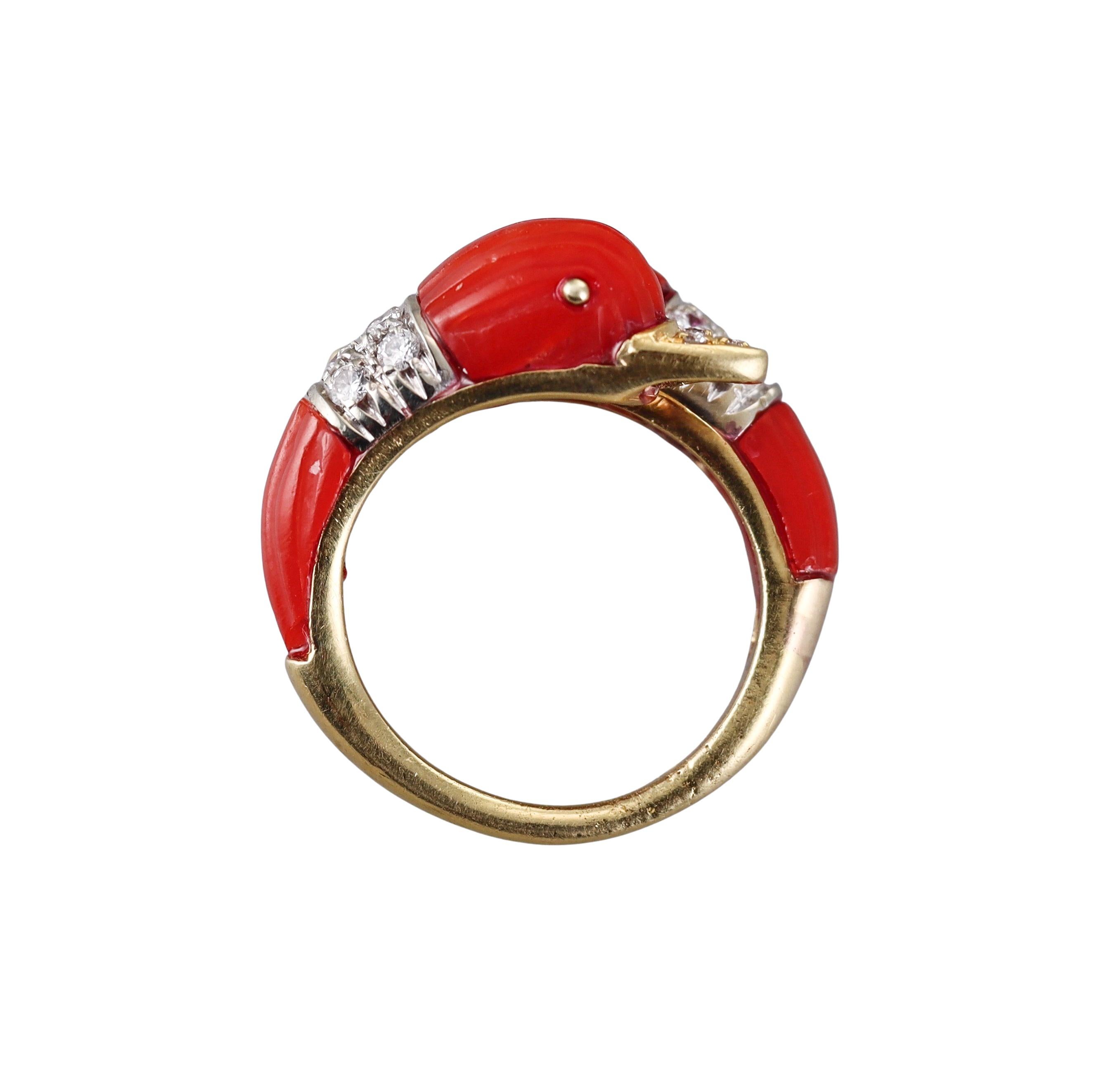 18k yellow gold bypass ring, featuring two dolphin heads, with carved coral and approx. 0.40ctw in diamonds. Small chips on the coral.
Ring size 7, top is 15mm wide.
Marked 18k, 8886, WW.
Weight - 8.7 grams.

