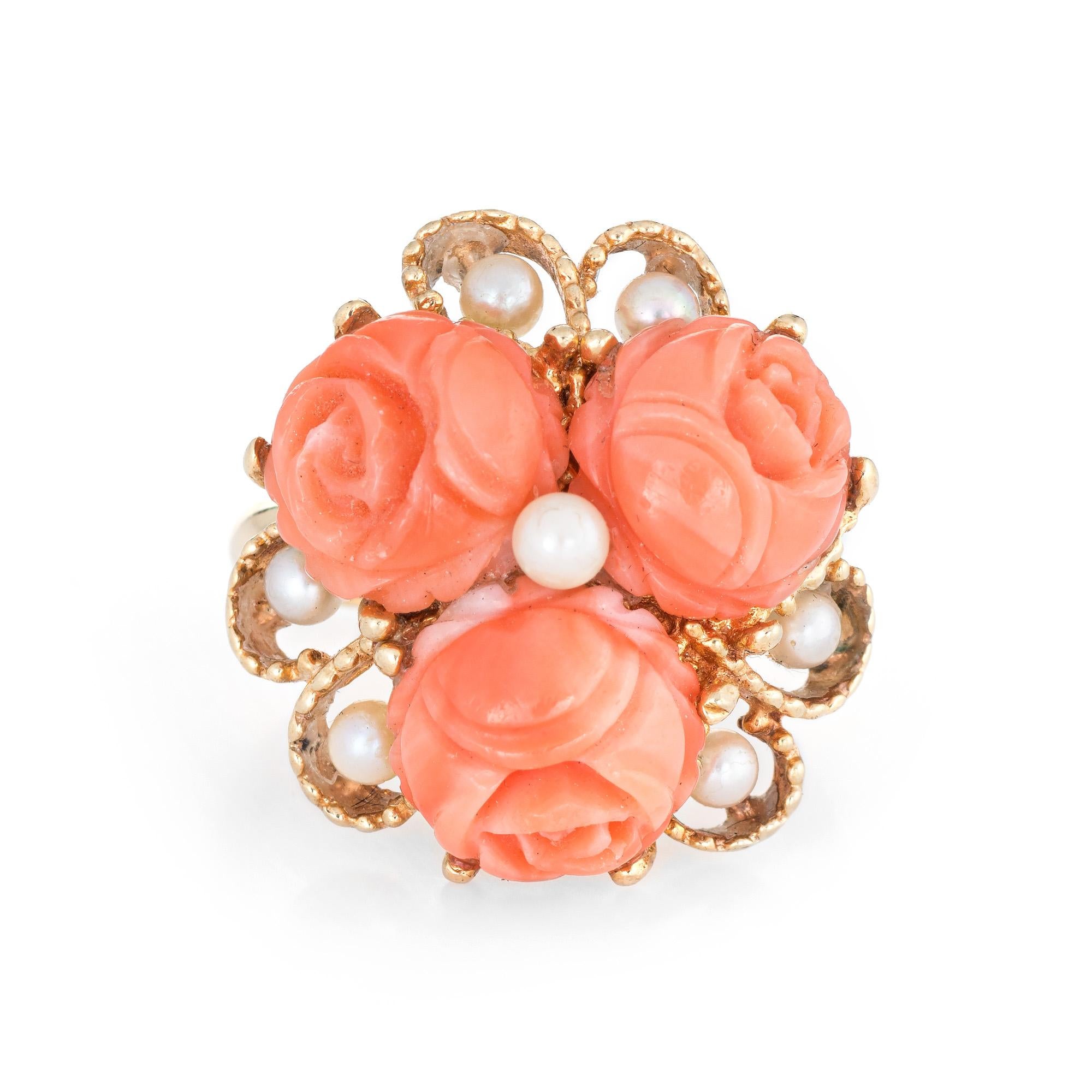 Stylish vintage coral cocktail ring (circa 1960s to 1970s) crafted in 14 karat yellow gold. 

Three pieces of coral each measure 9.5mm, accented with seven 3mm cultured pearls. The coral is in excellent condition and free of cracks or chips. 

The