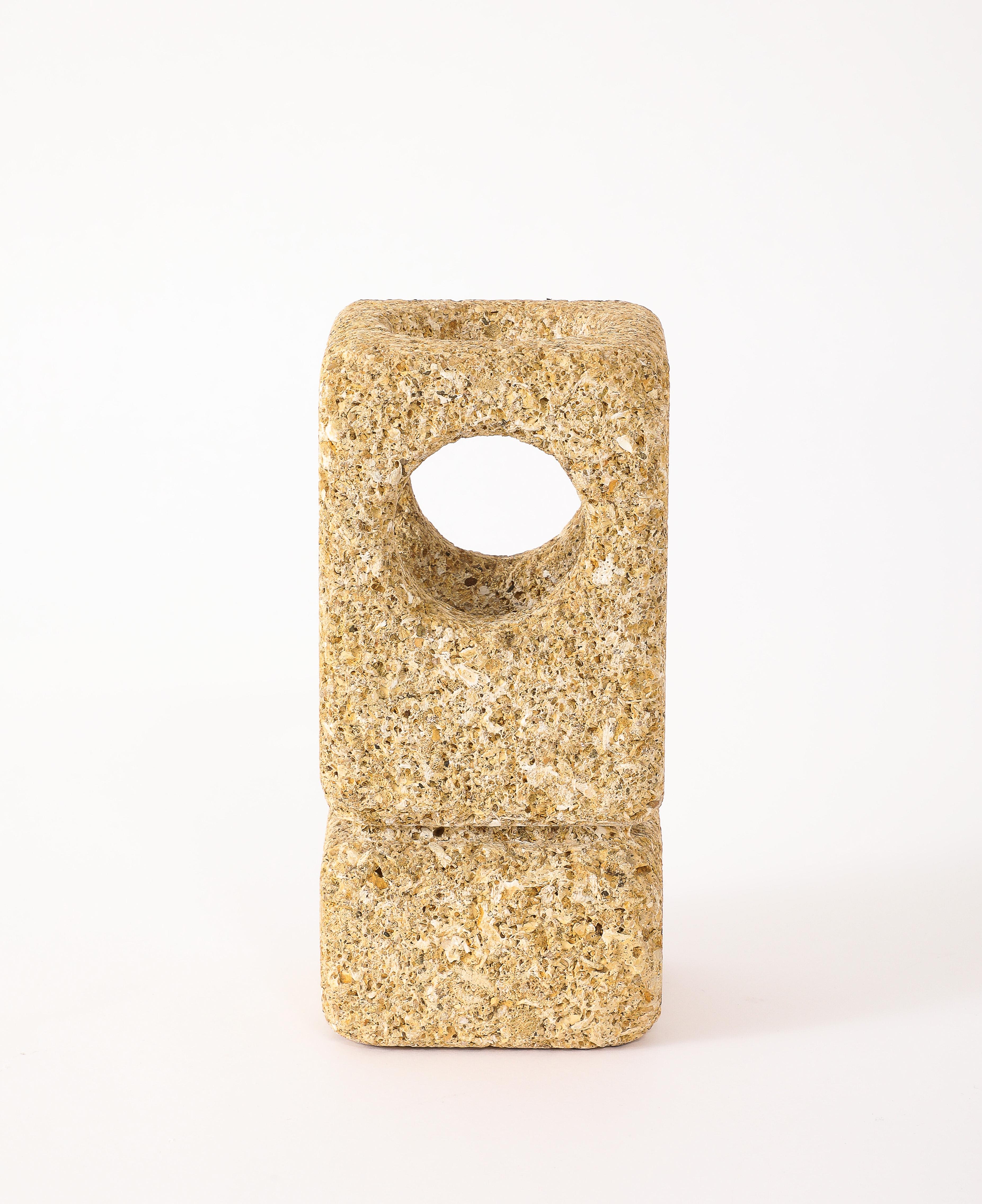 A solid hand-carved coral lamp with four round holes for indirect lighting.
