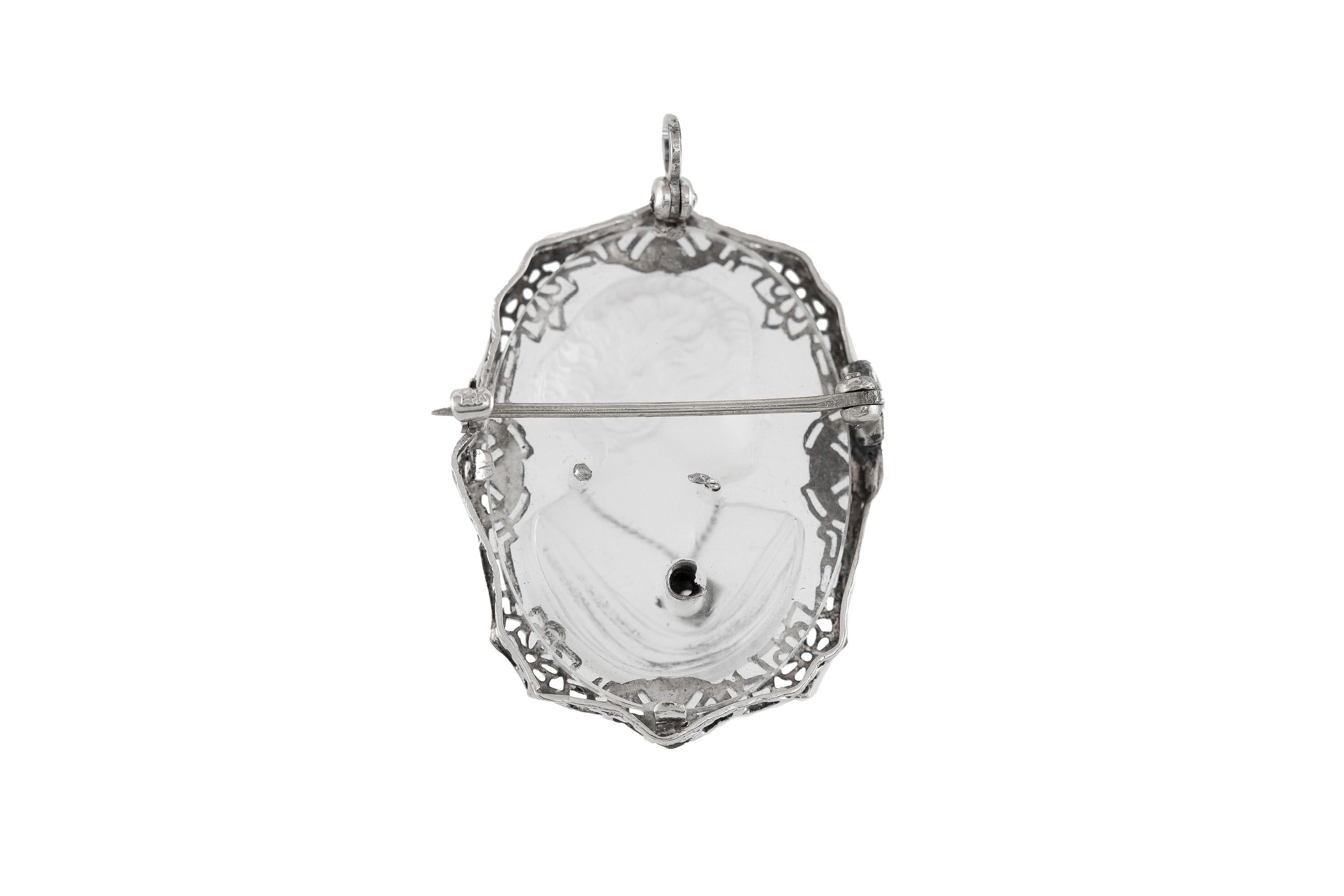 The pendannt is finely crafted in 14k white gold with carved crystal and one center diamond weighing approximately total of 0.05 carat.
Circa 1910.