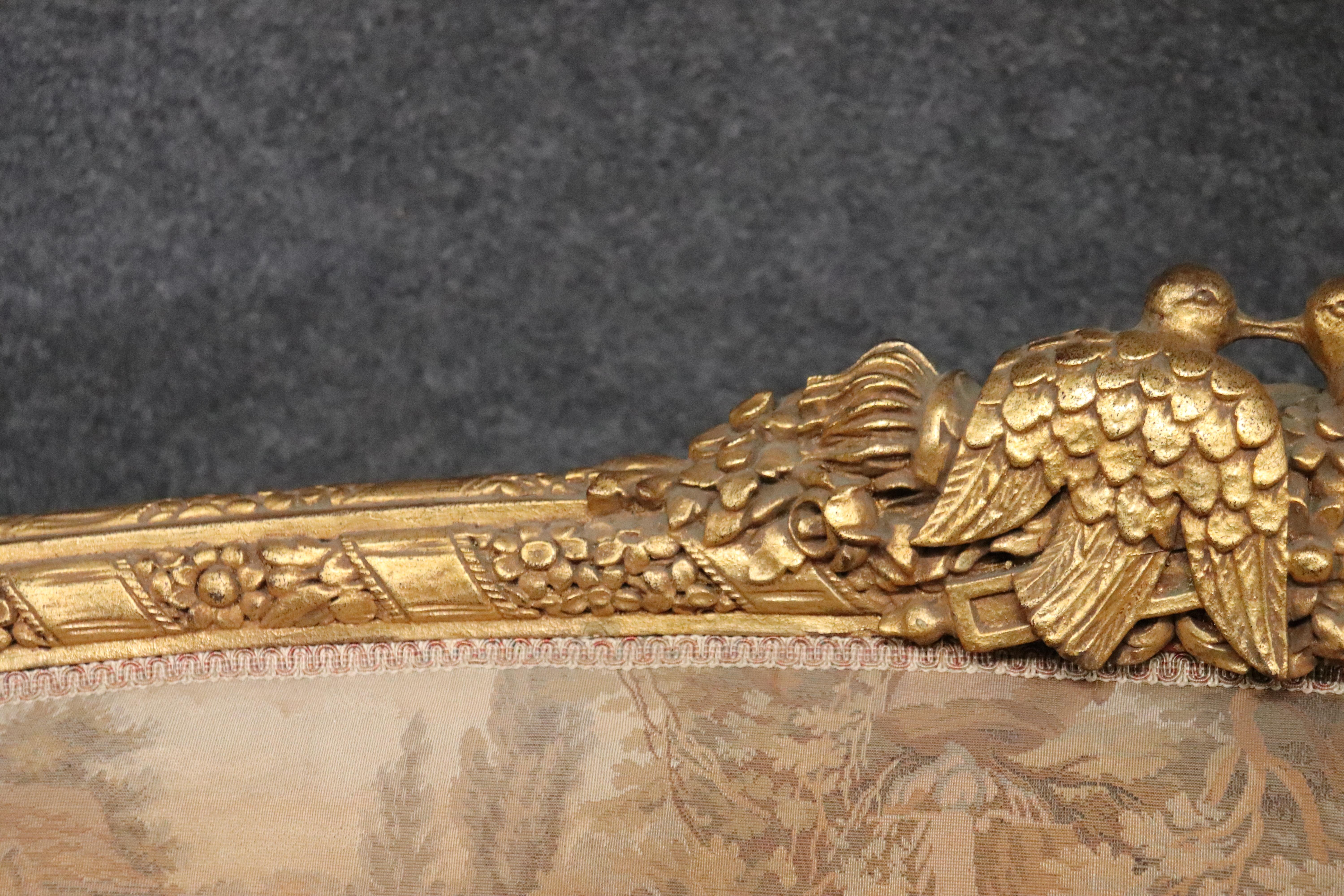 Early 20th Century Carved Curved Back French Louis XV Gilded Rams Head and Lovebirds Sofa Settee