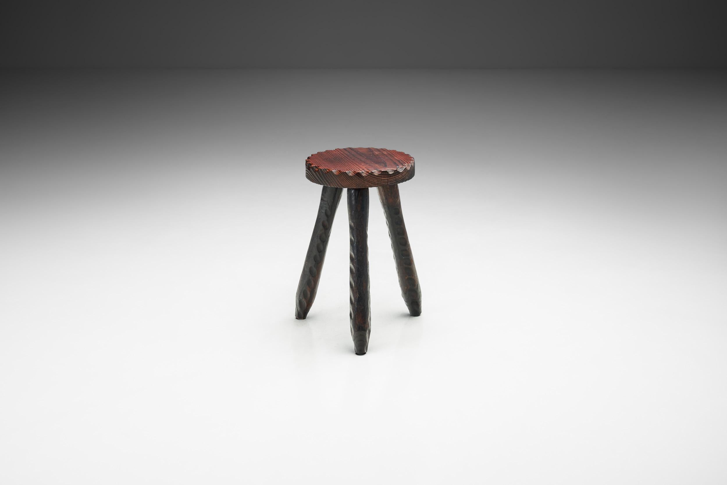 There are carved stools and then there is this carved stool. Utterly gorgeous with its organic cuts and dark wood finish, it could easily be considered a functional work of art. With a visual element of folklore, this stool is a true