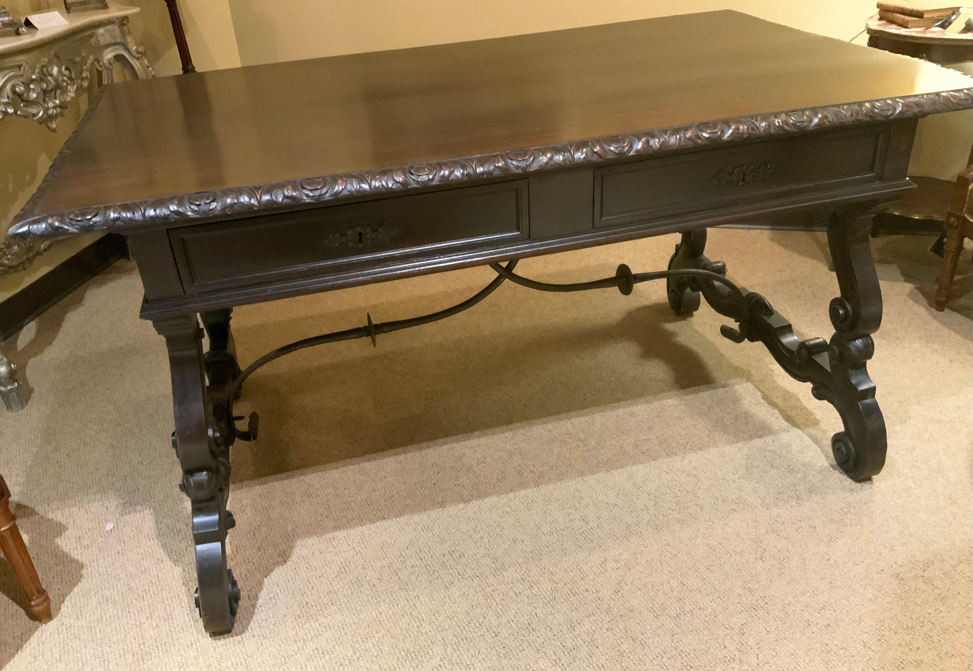Hand-Carved Carved desk from Spain with hand carving and iron stretcher  For Sale