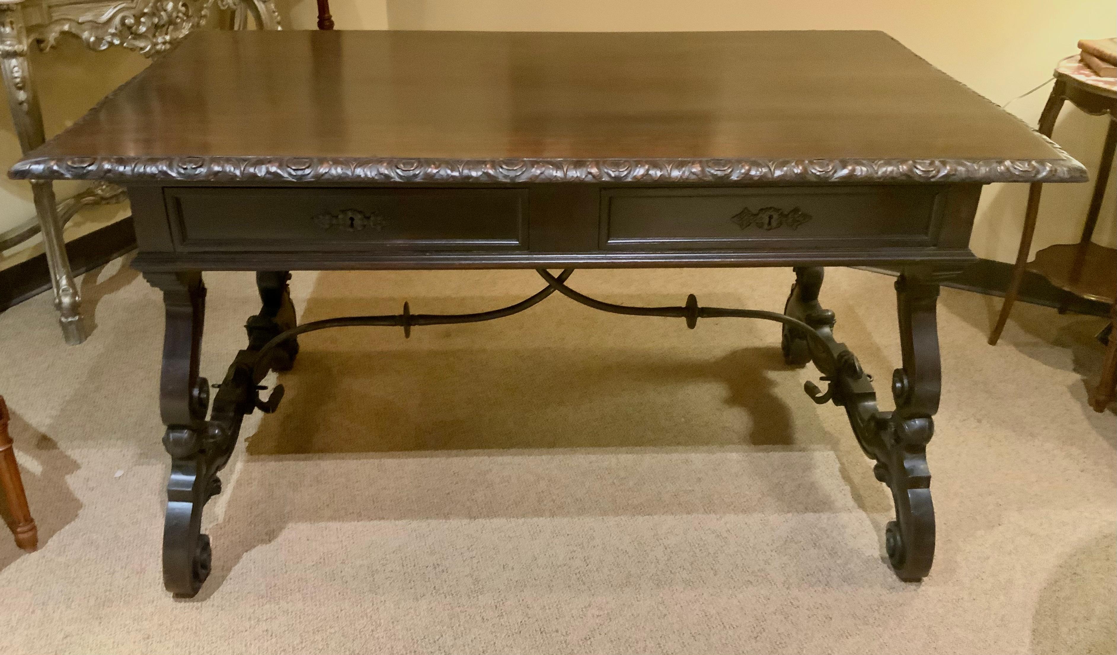 Carved desk from Spain with hand carving and iron stretcher  In Excellent Condition For Sale In Houston, TX