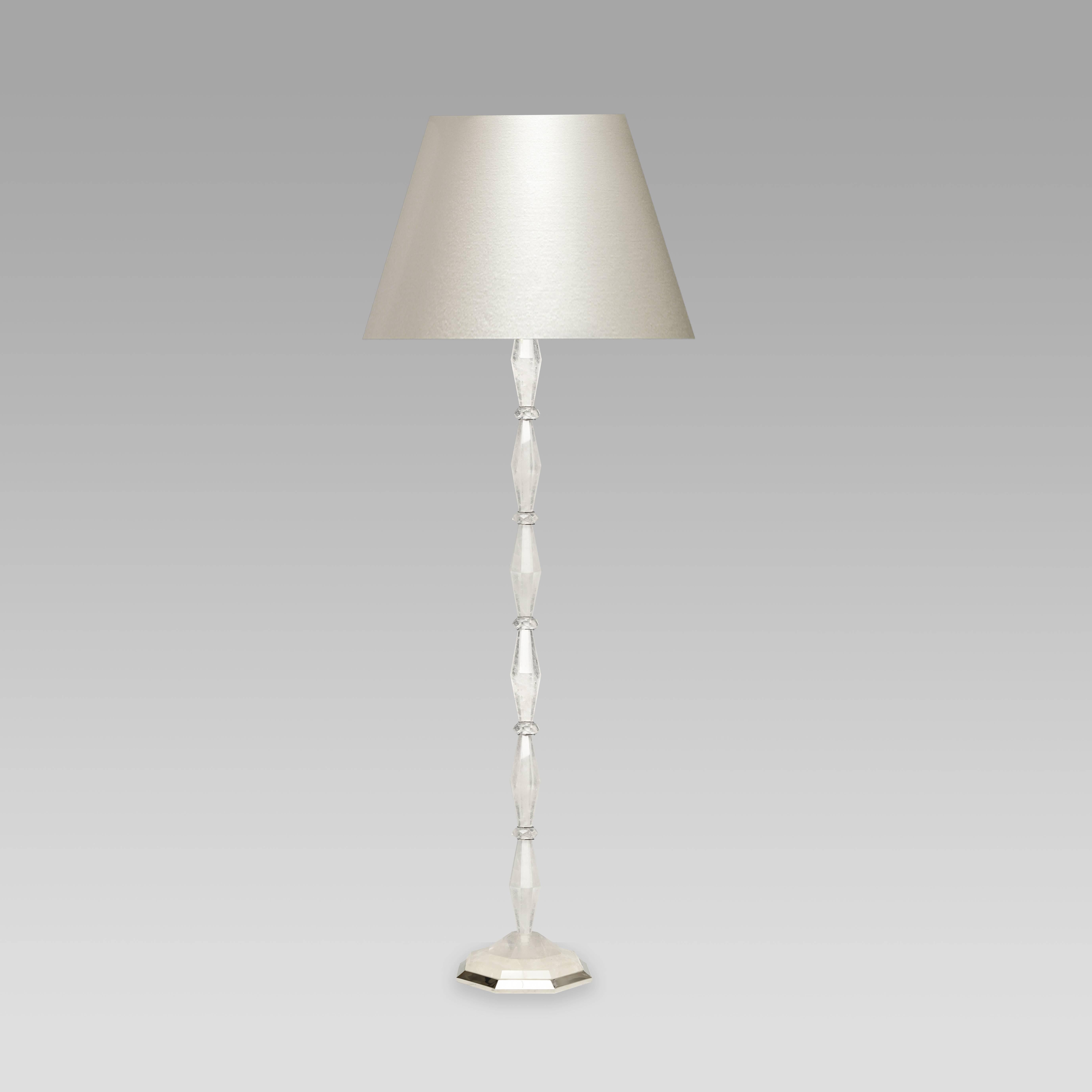 A carved diamond form rock crystal quartz floor lamp with nickel base, created by Phoenix Gallery, NYC.
Measure: To the rock crystal 56 inch H.
(Lampshade not included).
 