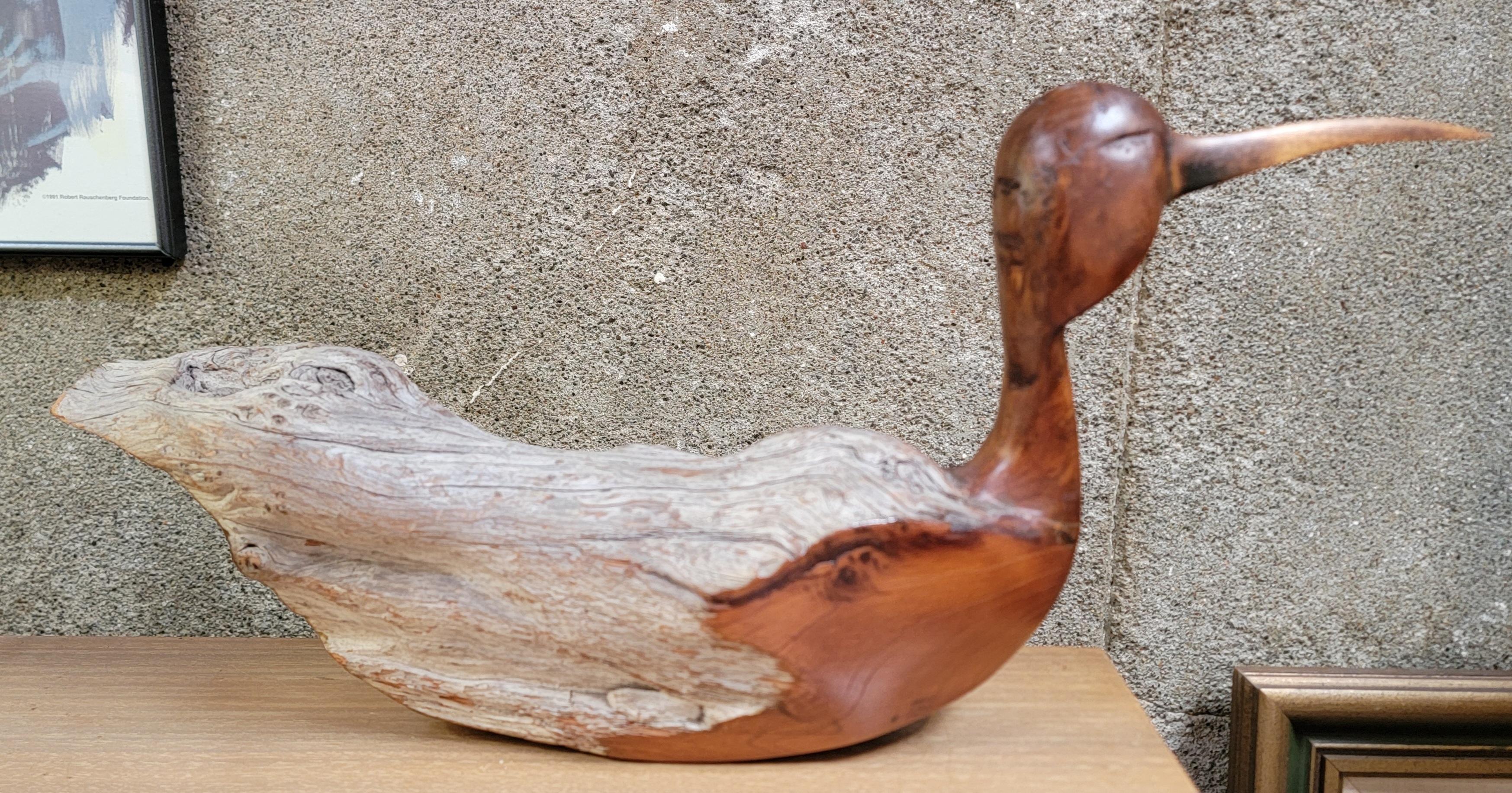 A hand carved driftwood sculpture of a waterfowl bird by Kevin Morin. Made of redwood and myrtle-wood. Artist signed 