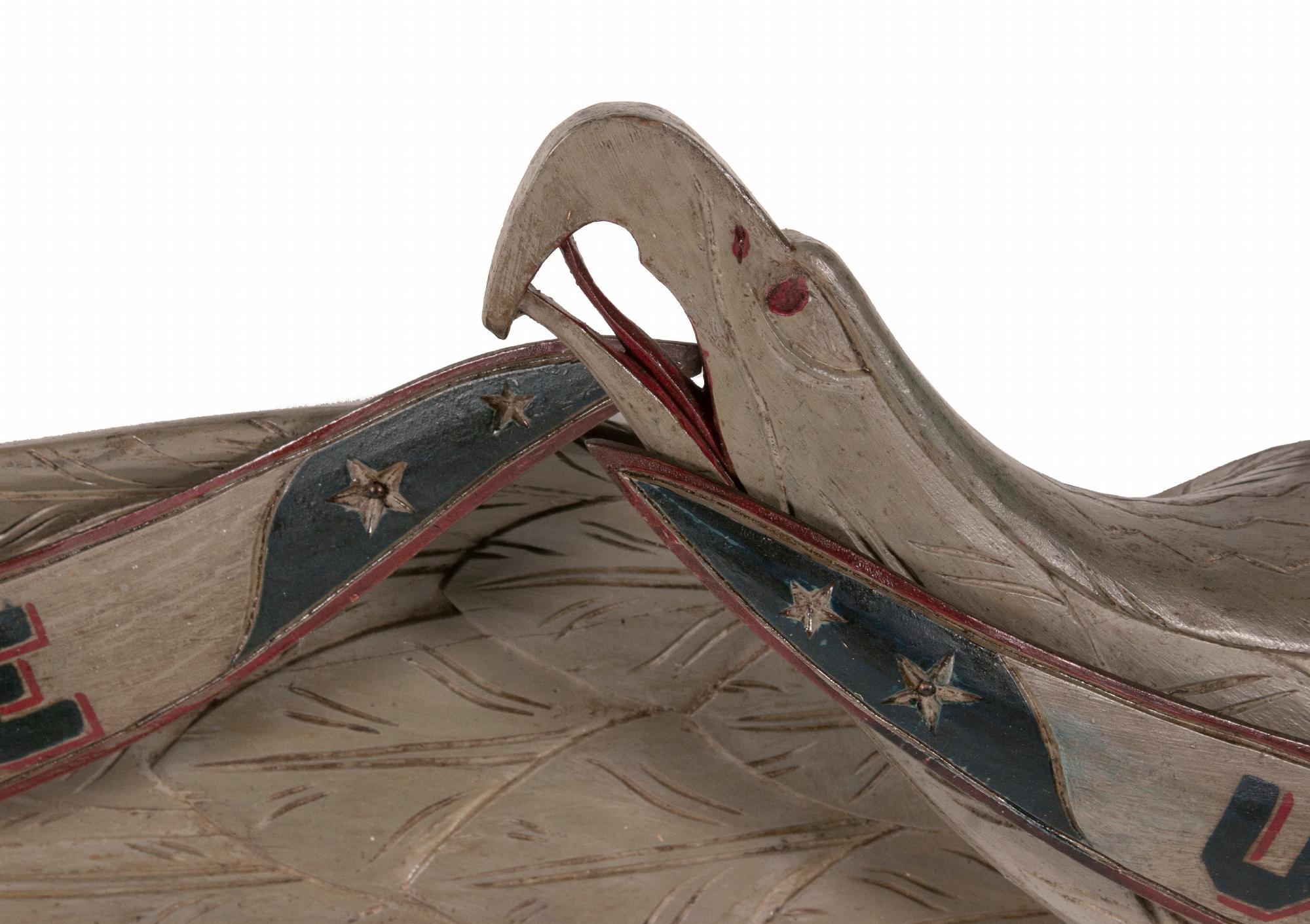 Carved eagle from the shop of John Haley Bellamy, unusual in grey paint, with elongated format and his traditional “DON’T GIVE UP THE SHIP” streamer, circa 1890-1905:

Carved wooden eagle, attributed to the shop of the most renowned, American,