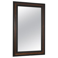 Carved ebonised wood mirror and trompe l'oeil turshell, XIXth c.