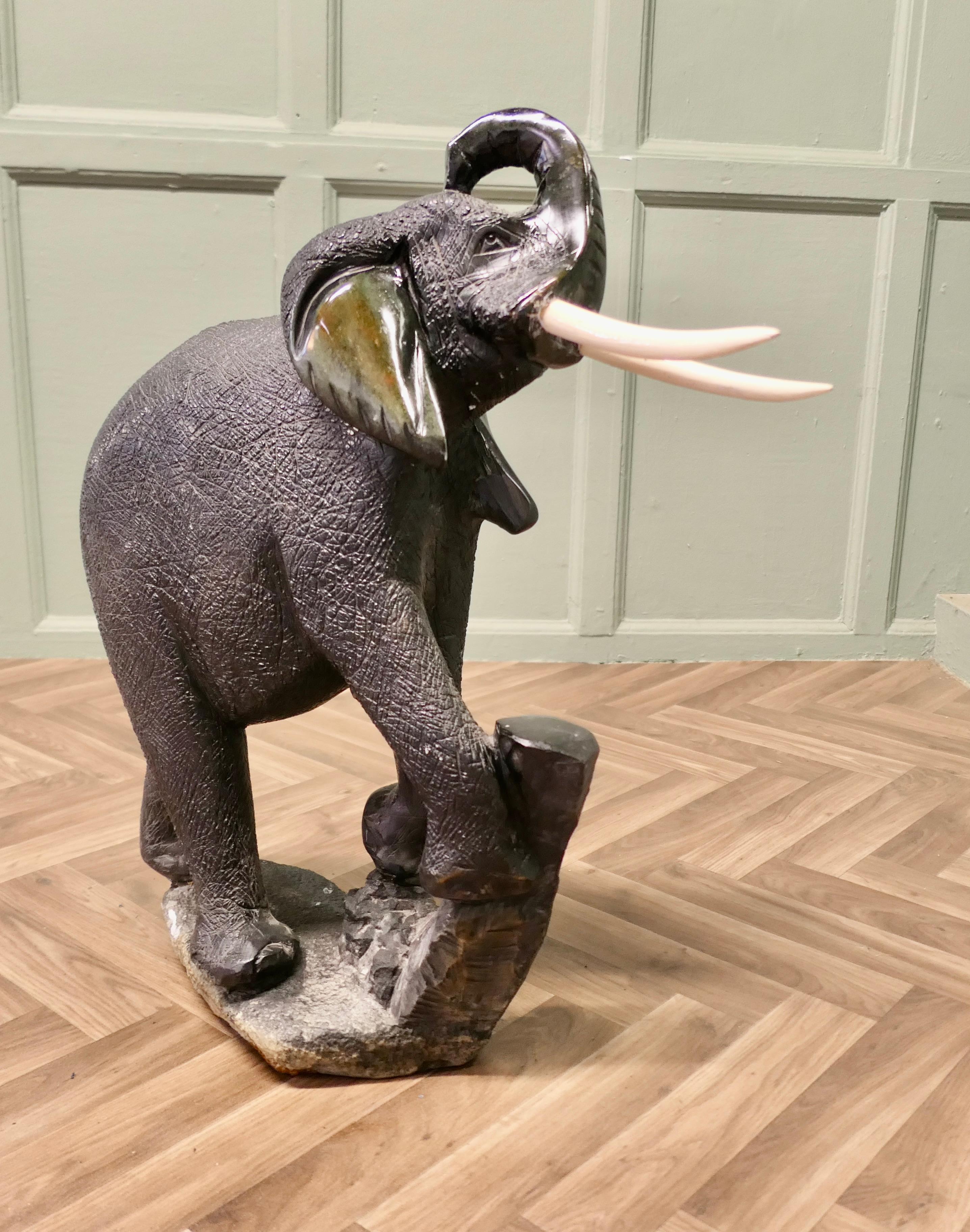 Carved Elephant, one piece Marble Sculpture 

This extremely heavy piece is carved in one piece from a green marble rock, the “Tusks are made in wood”, the carving is very cleverly done showing the deeply grooved and wrinkled skin of the elephant