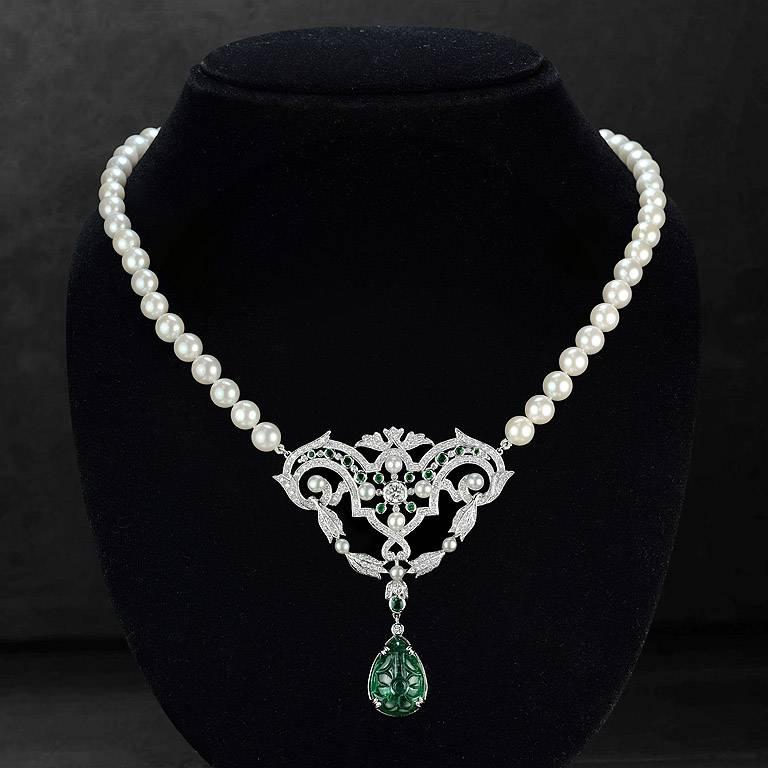 Carved Emerald from Colombia 11.37 Carat set on 18K White Gold Pendant with Round Cut Diamond 1 piece 0.15 Carat on the center. Surrounding by Emerald 13 pcs. 0.70 Carat, Brilliant Cut Diamond total 163 pcs. 1.42 Carat and Fresh Water Pearl 9 pieces