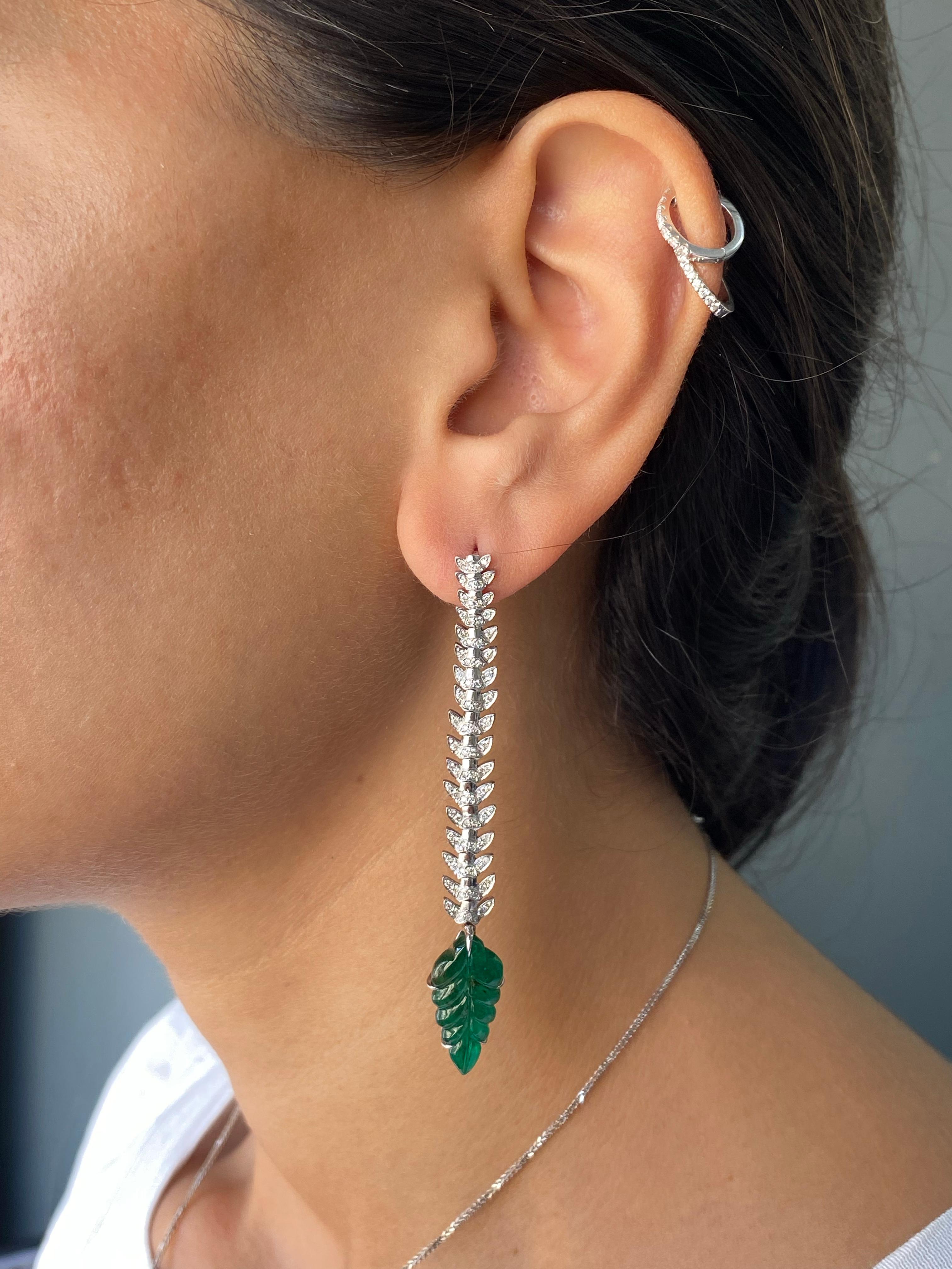A stunning pair of art-deco 8 carat Zambian Emerald and Diamond dangle earrings, set in solid 18K White Gold. The earrings are very flexible and light weight, they are around 2.75 inches long, and come with a push-pull backing.
Please feel free to