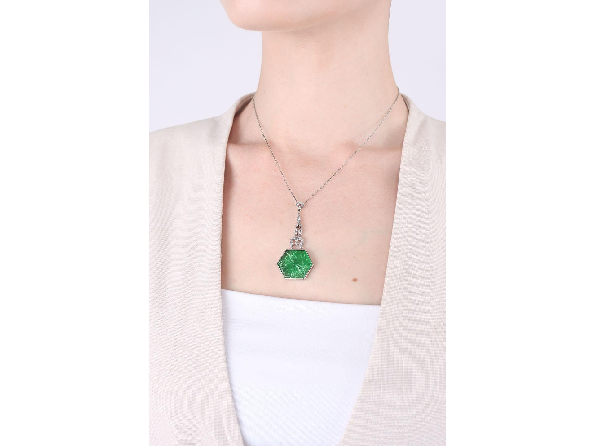 Art Deco Carved emerald and diamond pendant, circa 1925. For Sale