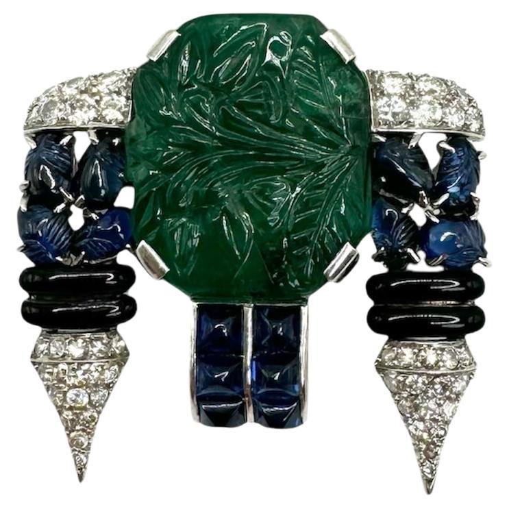 Art Deco Carved Emerald, Sapphire, Onyx & Diamond Brooch For Sale