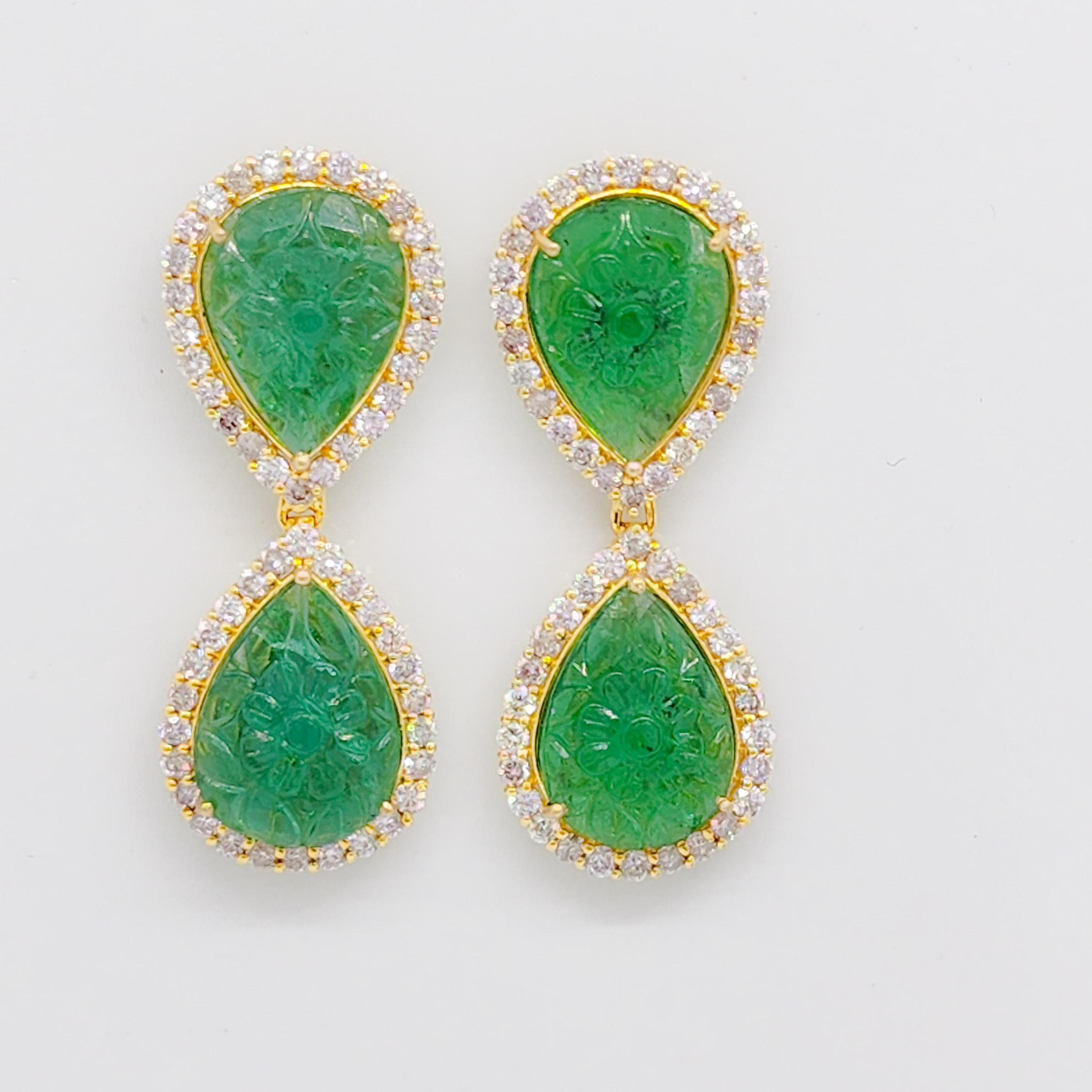 Beautiful 16.64 ct. carved emerald pear shapes with 2.74 ct. good quality white diamond rounds.  Handmade in 18k yellow gold.  