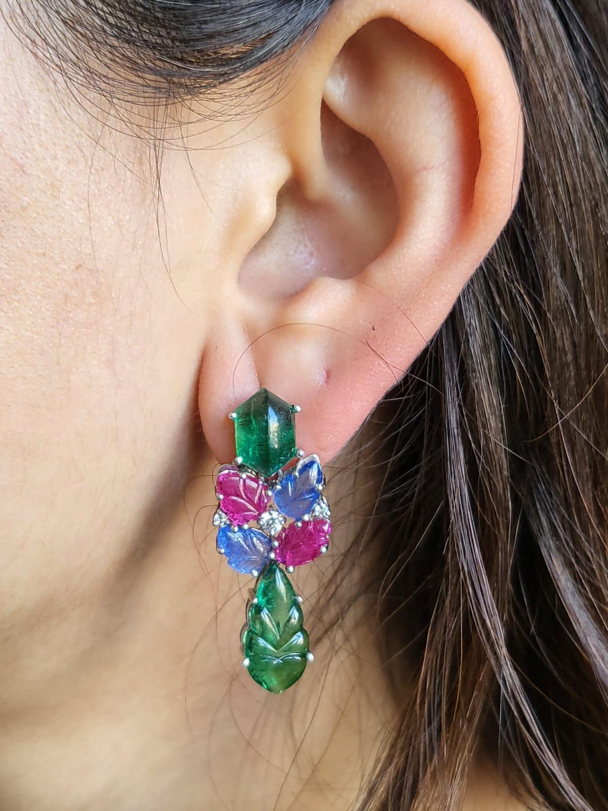 A very classic and beautiful, Blue Sapphire, Emerald & Ruby Tutti Frutti Dangle Earrings set in 18K White Gold & Diamonds. The weight of the Emeralds is 4.78 carats + 6.53 carats(Top & Bottom pair). The Emeralds are of superior quality and are