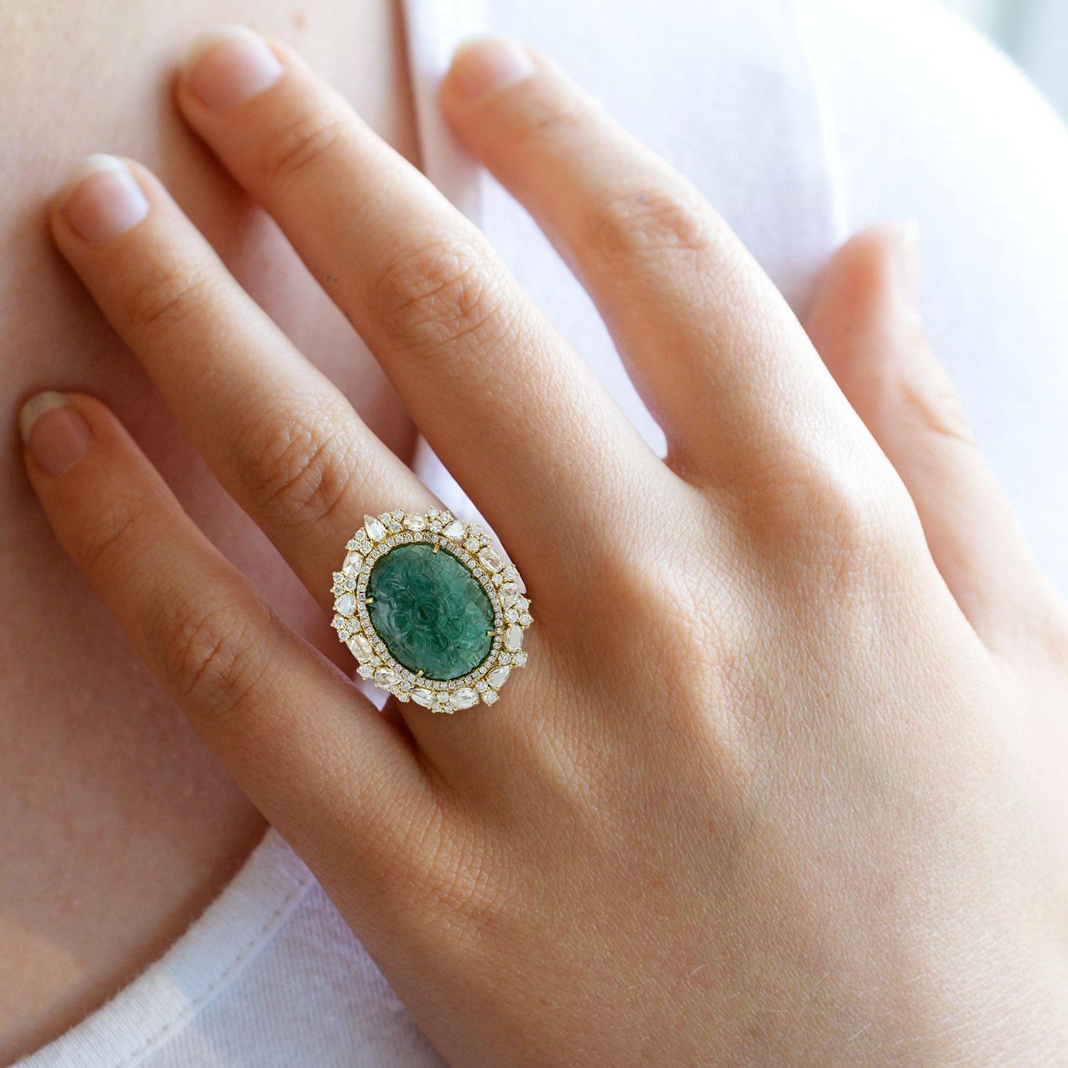 A stunning statement ring cast in 18-karat gold. It is hand set in 15.74 carats carved emerald & illuminated with 2.9 carats of sparkling diamonds. 

The ring is a size 7 and may be resized to larger or smaller upon request. 
FOLLOW MEGHNA JEWELS