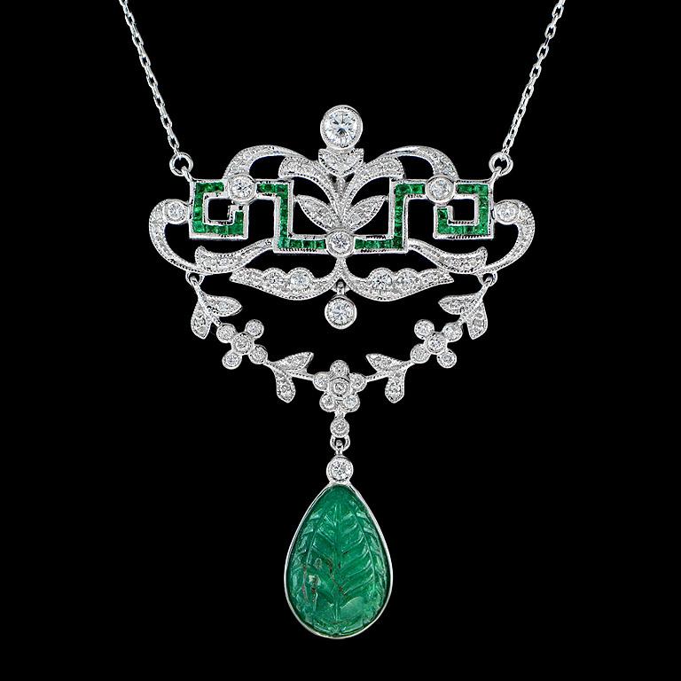 This Carved Emerald Diamonds Necklace was made in 18 Karat White Gold.  It's an ideal must-need piece of jewelry.
The Colombian Emerald was carefully carved and have a final weight of 4.70 Carat.  Glittering and Sparkling, we have this one made with