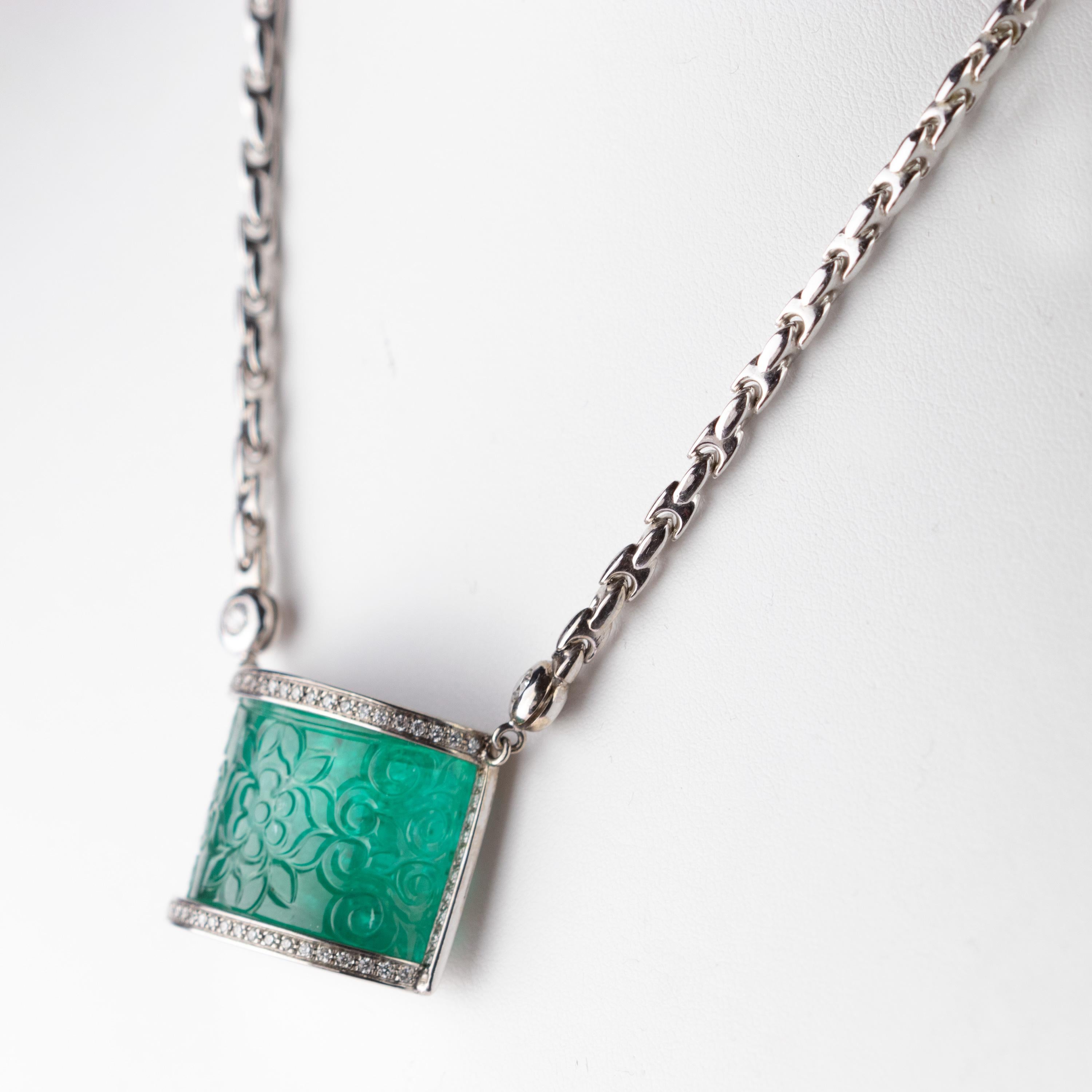 Inspired by South American treasures, a beautiful design with a large and impressive look. This elegant necklace is set with a geometric square carved emerald bar chain pendant with a curved shape, 46 carat weight. The 45 carats emerald is carved