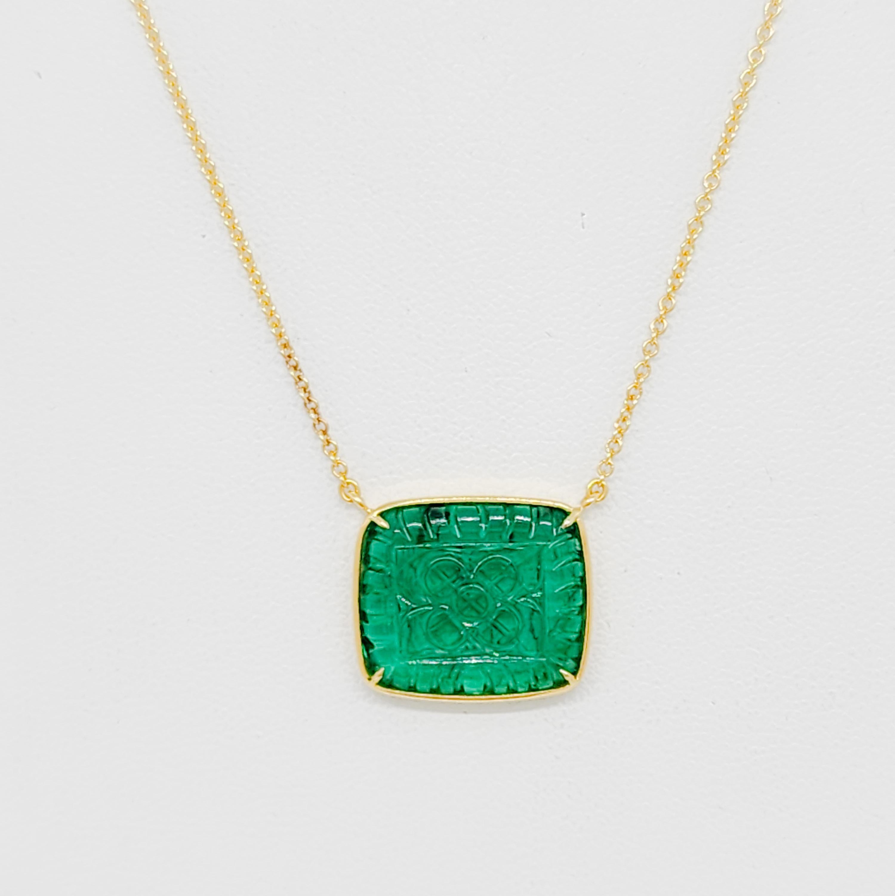 Beautiful 6.84 ct. carved emerald rectangle in a handmade 18k yellow gold bezel.  Length of chain is  18