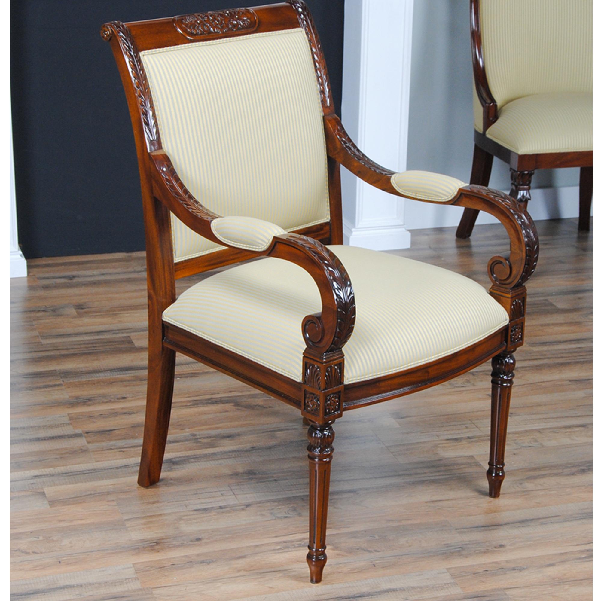 The set of 10 Carved Empire Upholstered Chairs comprise of a group with 2 arm chairs and 8 side chairs. All chairs with a carved top rail and featuring a fully upholstered back which gives this chair a great quality designer look as well as a