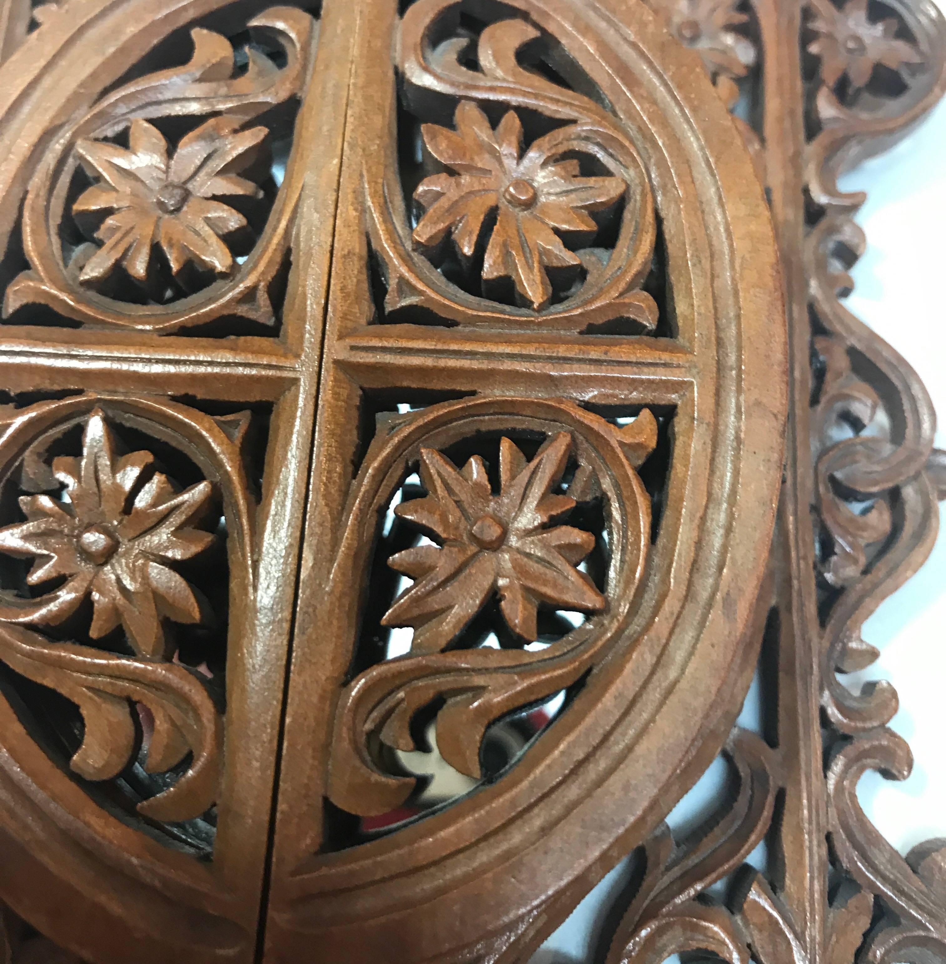 A Gothic style frame with filigree carved doors that open to reveal a mirror, which can be used as a picture frame. Delicate all over carving of boxwood.