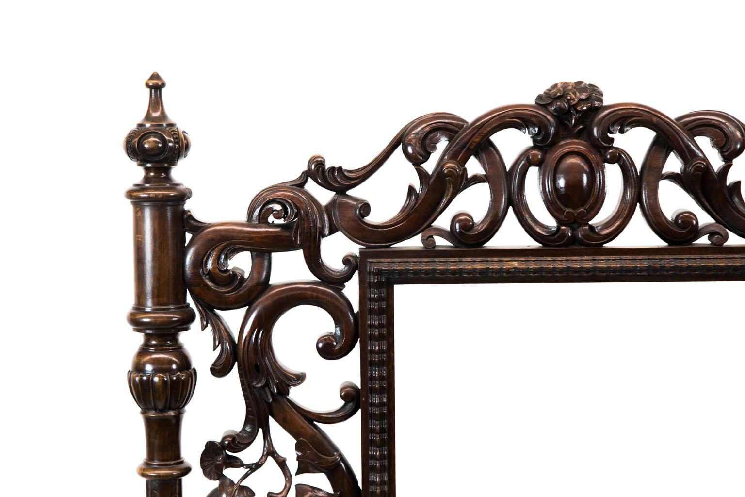 Carved English walnut fire screen, has an empty customized center panel that is surrounded by floral and leaf branch carved arabesques. The column supports are fluted and carved with incised featherings.
  