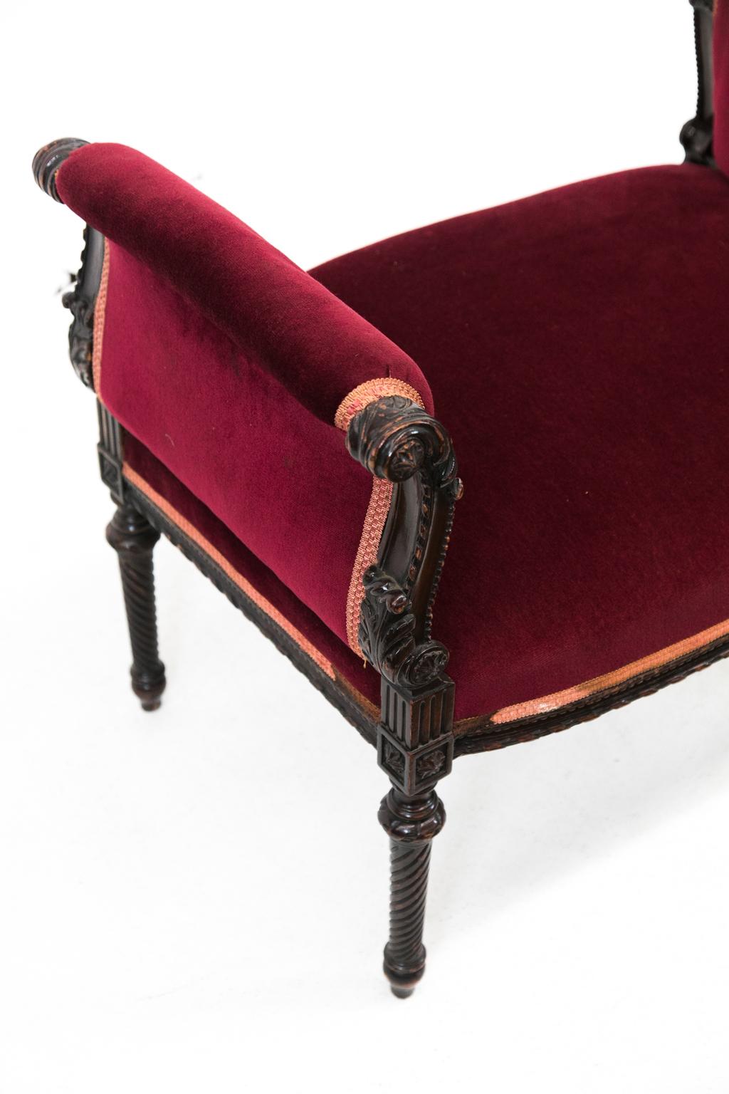 Carved English Window bench, has scrolled arms carved with beadwork and acanthus leaves with spiral turned legs and a gadrooned carved apron. The velvet fabric has some stains.
 