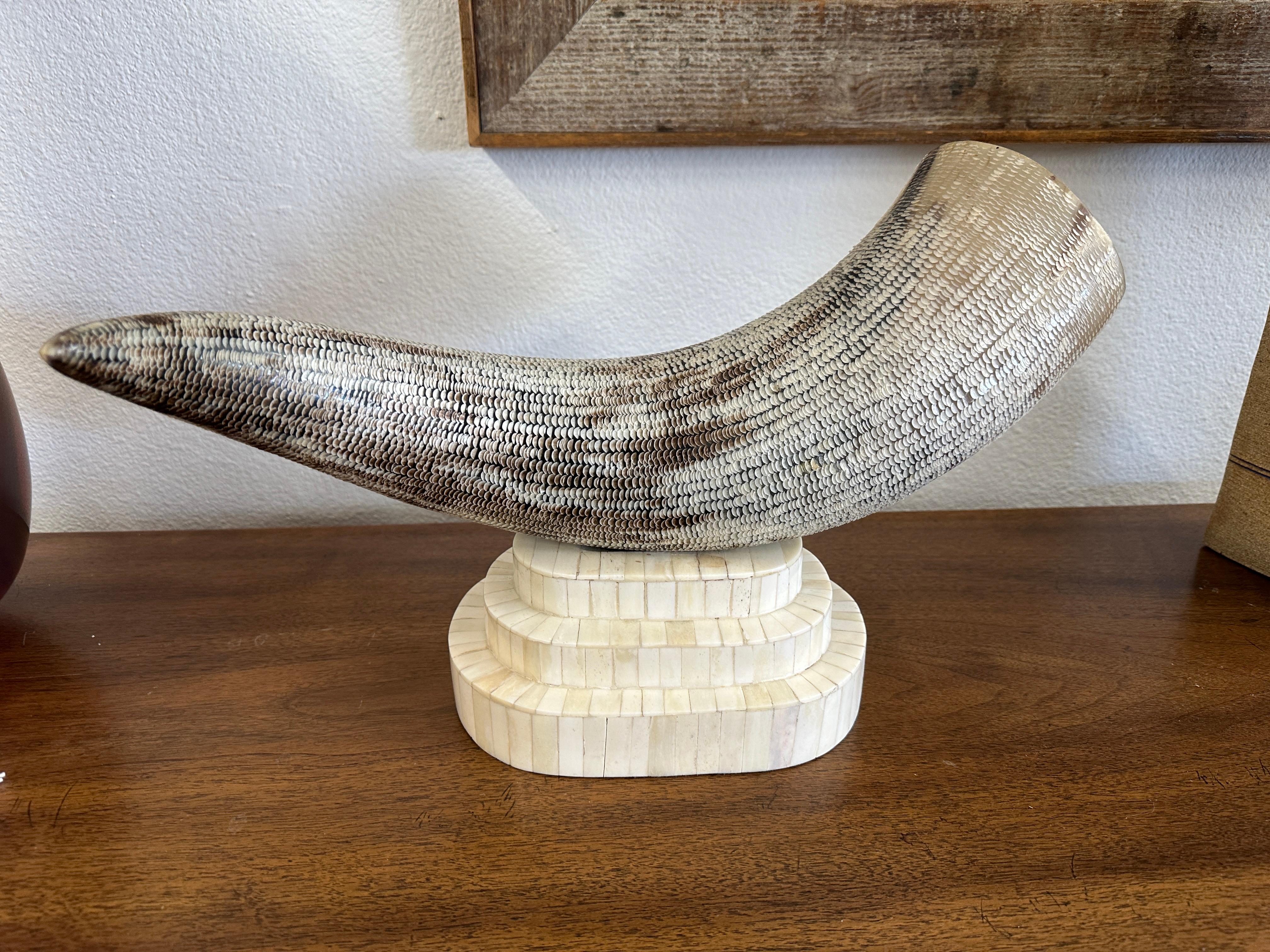 An interesting decorative sculpture, this etched horn is mounted on a tesselated bone base. It is very much in the style of Maitland Smith or a similar company. The horn is likely a water Buffalo or Steer. it has little crescents etched all over. It