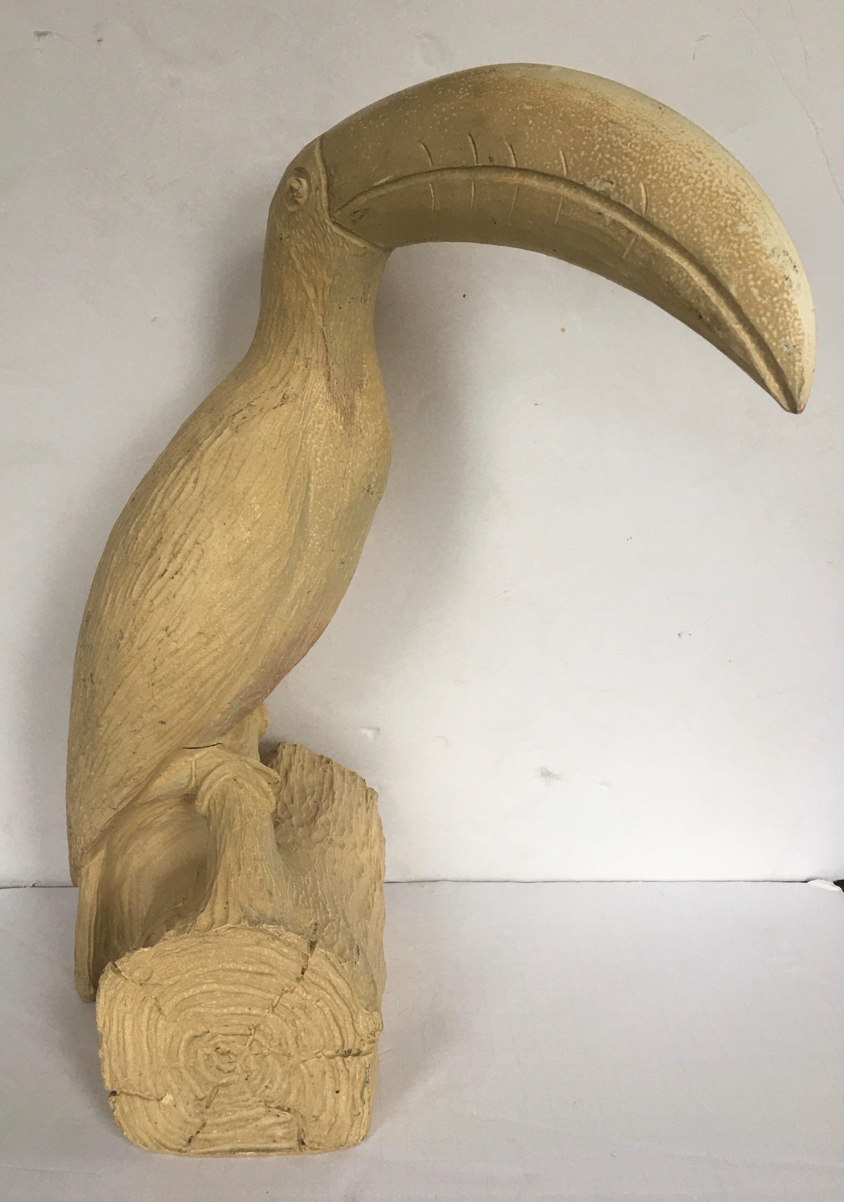 Large carved heavyweight faux bois toucan bird sculpture featuring original light beige washed finish.