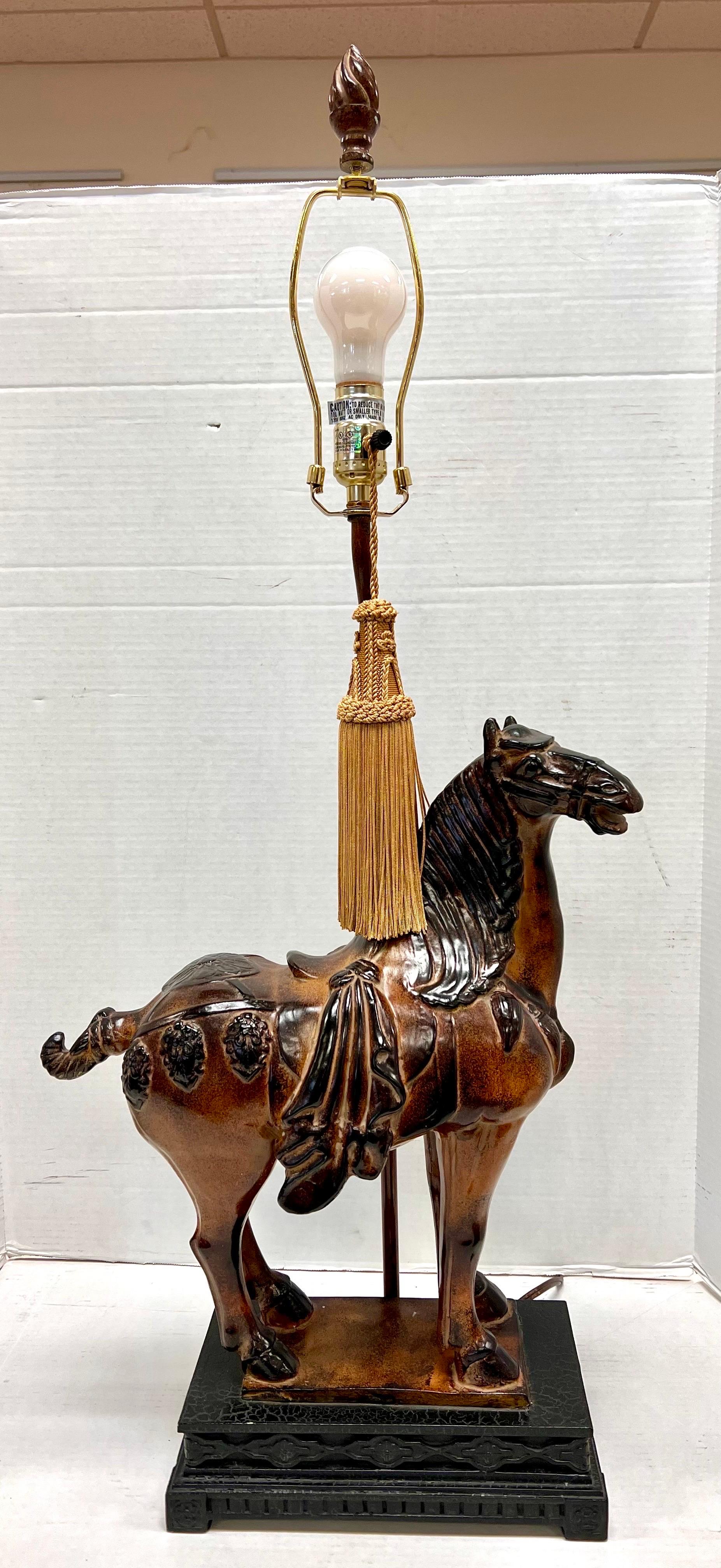 Carved Chinese Dynasty horse mounted on a carved wood base and topped with a suede leather shade and wood finial. The shade alone is 18